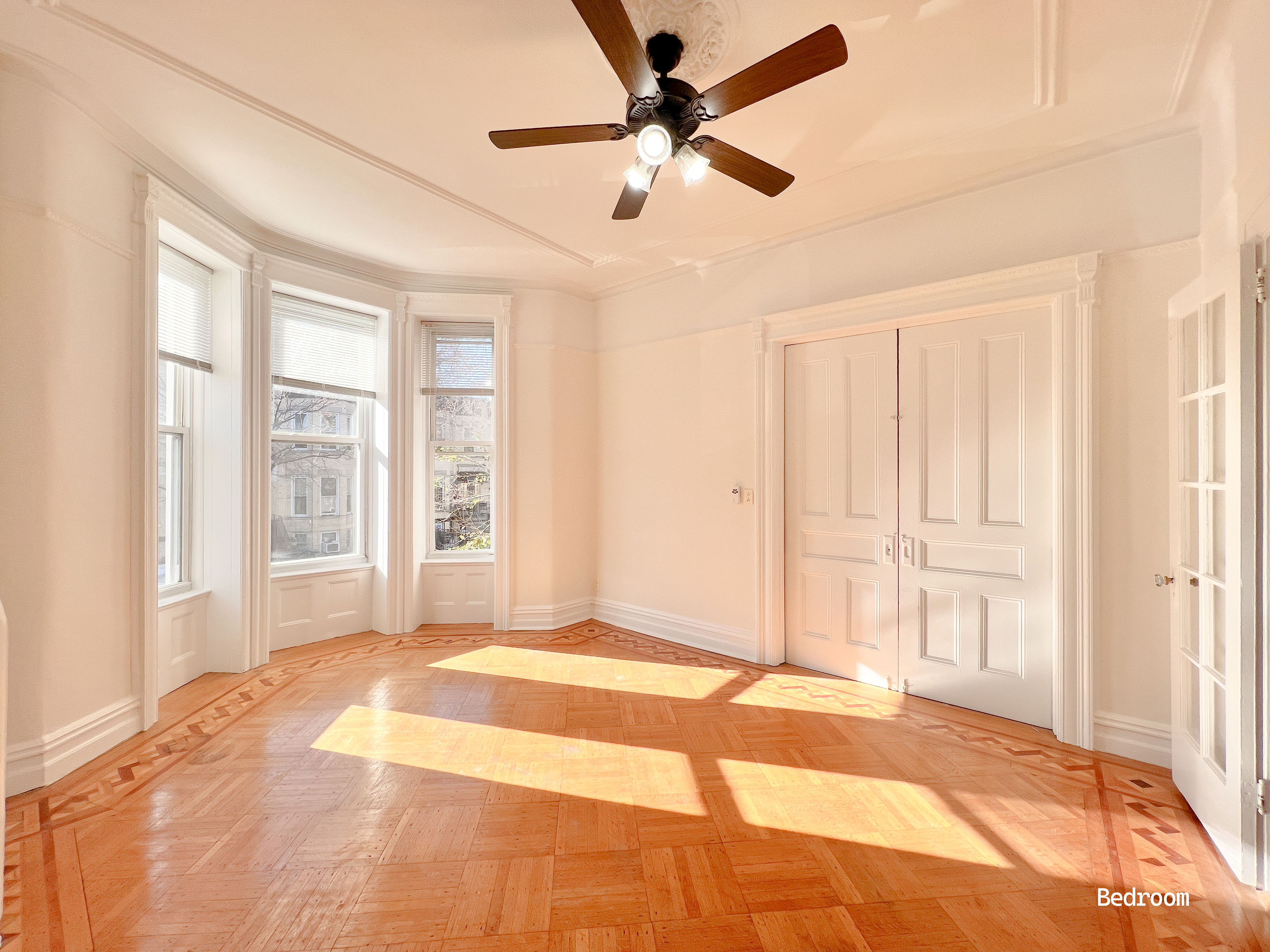 a view of a livingroom with a ceiling fan and window