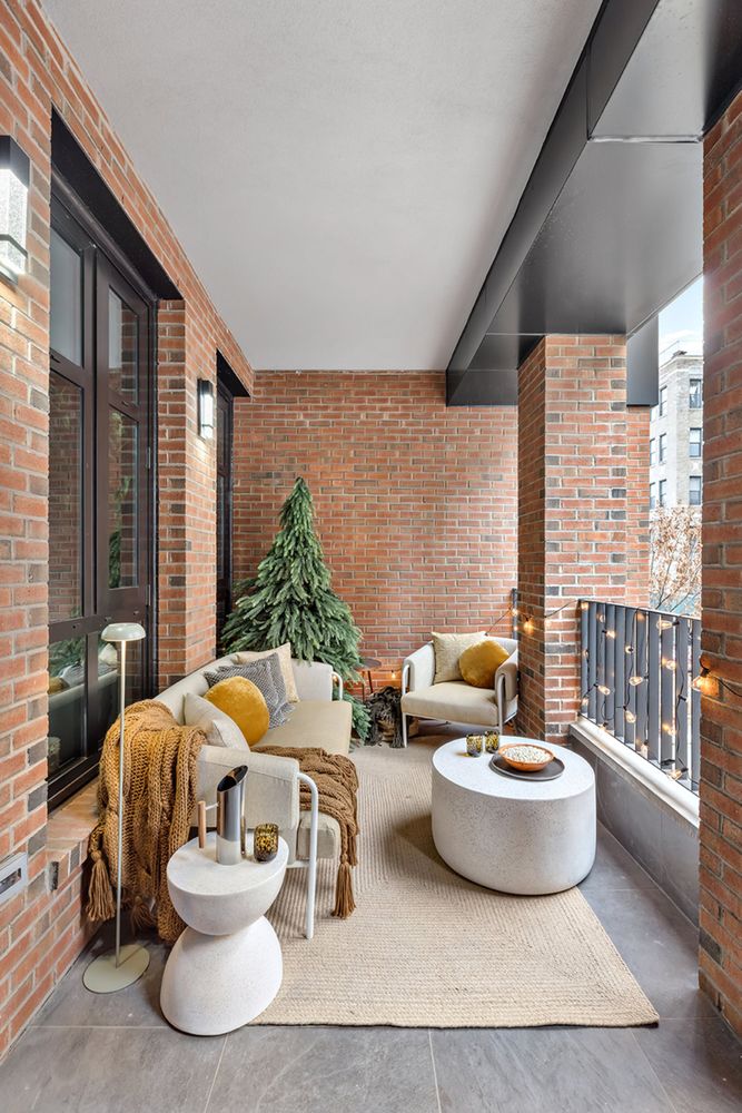 a living room with furniture and a floor to ceiling window