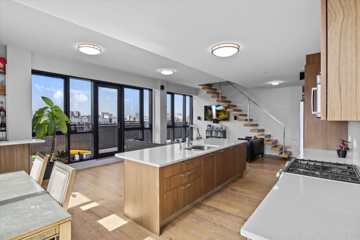 a large white kitchen with a large window