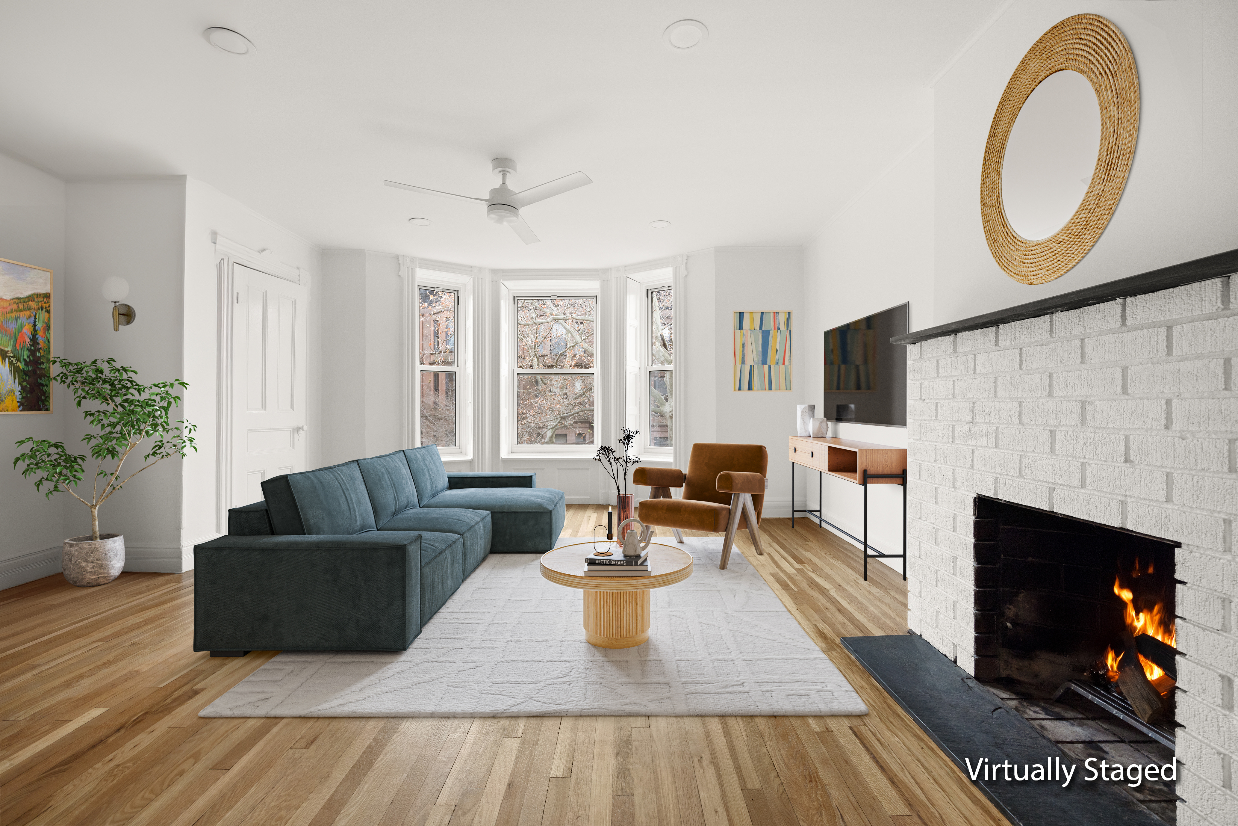 a living room with furniture a flat screen tv and a fireplace