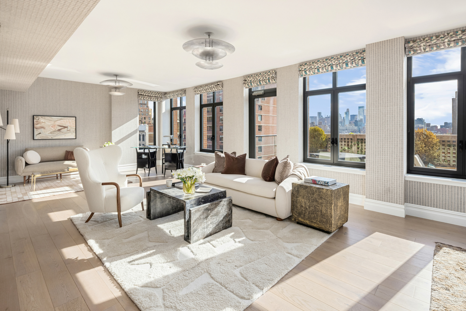 a living room with furniture and large windows