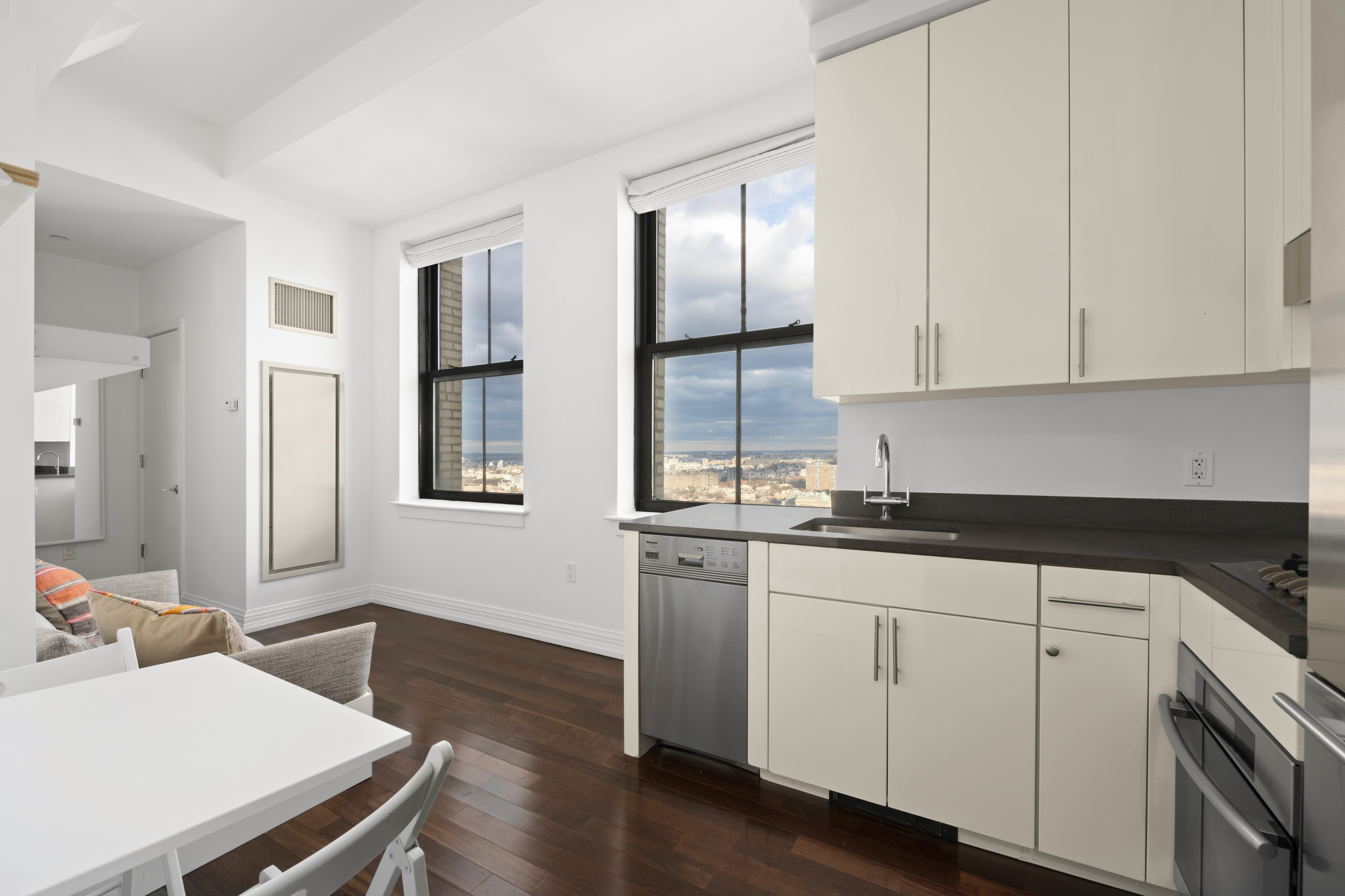 a kitchen with a sink cabinets and wooden floor