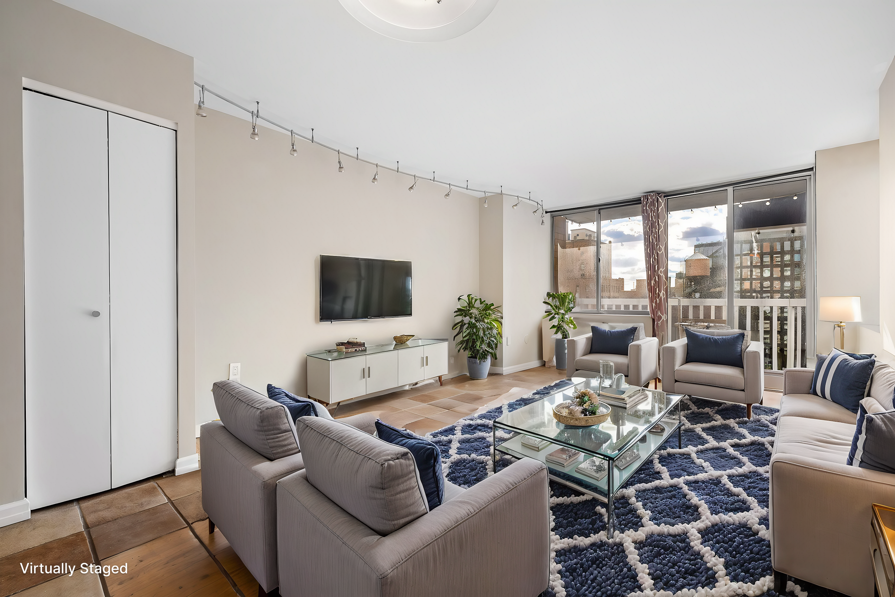 a living room with furniture a flat screen tv and a large window