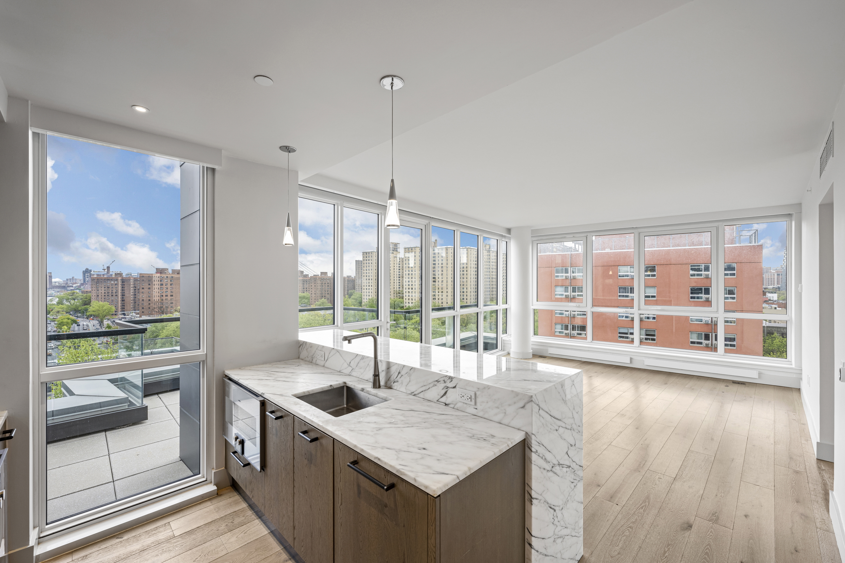 a kitchen with stainless steel appliances granite countertop sink stove and wooden floor