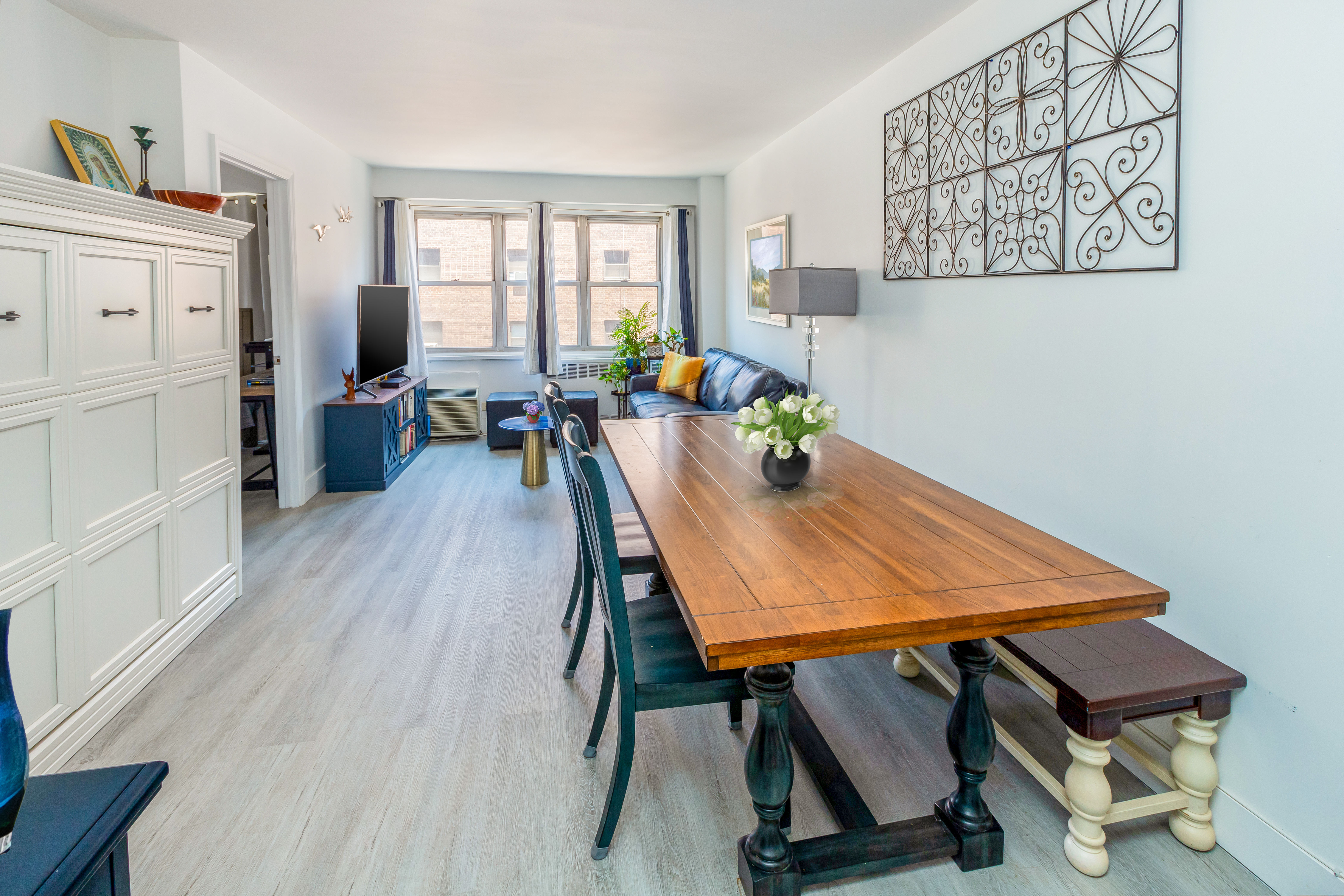 a view of a dining room with furniture window and wooden floor