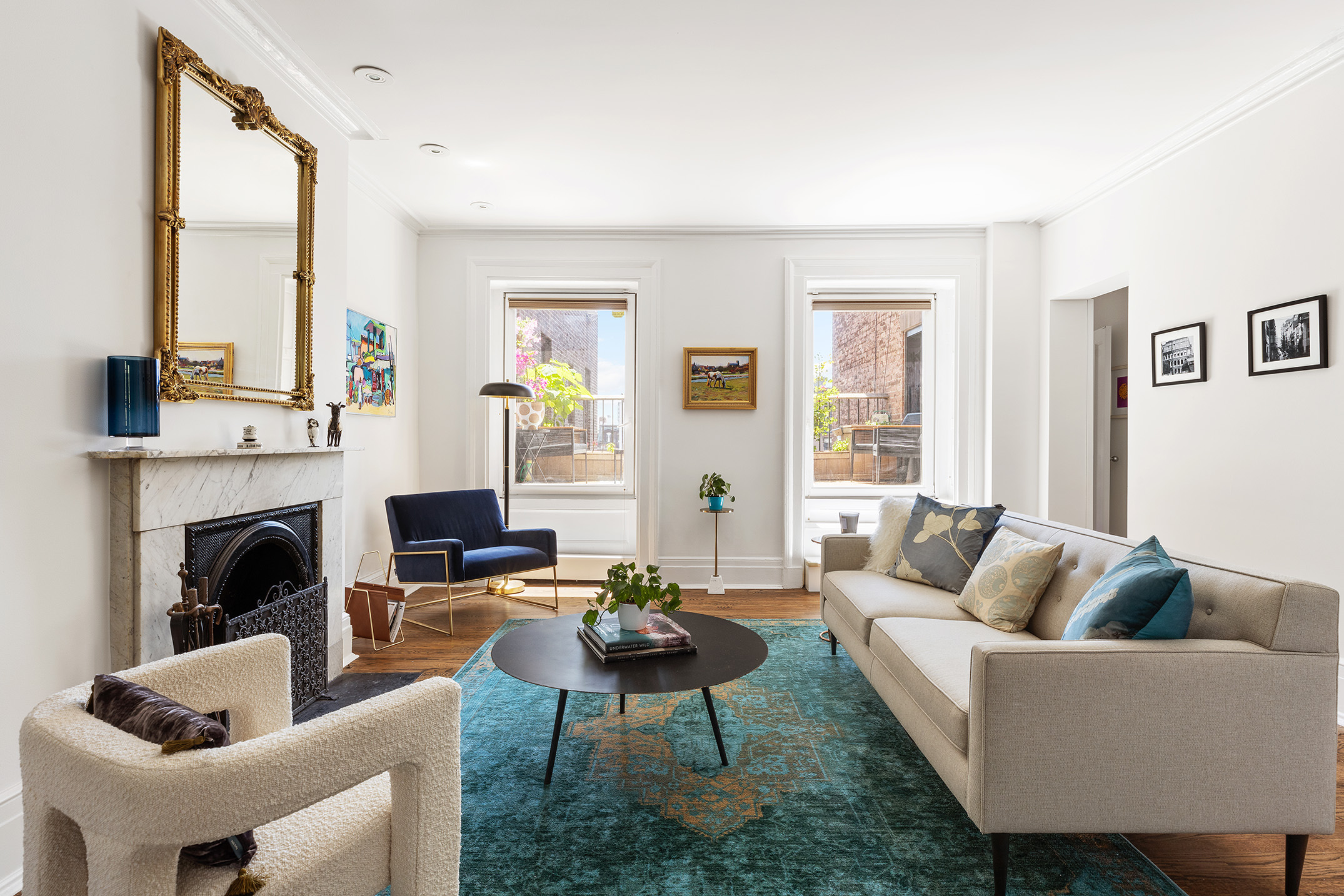 a living room with furniture a large window and a fireplace