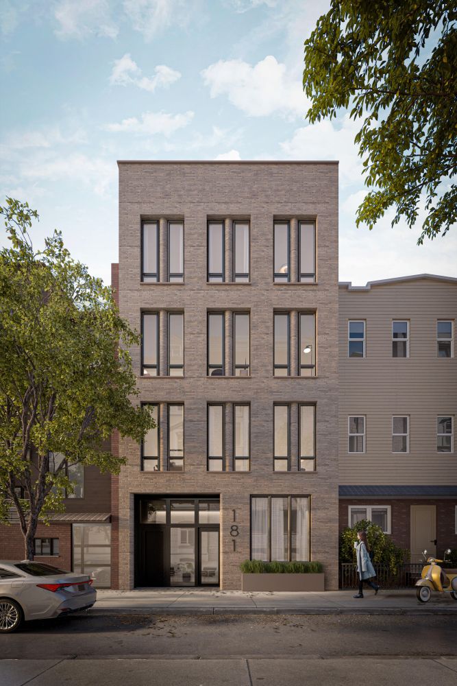 a front view of a residential apartment building with a yard