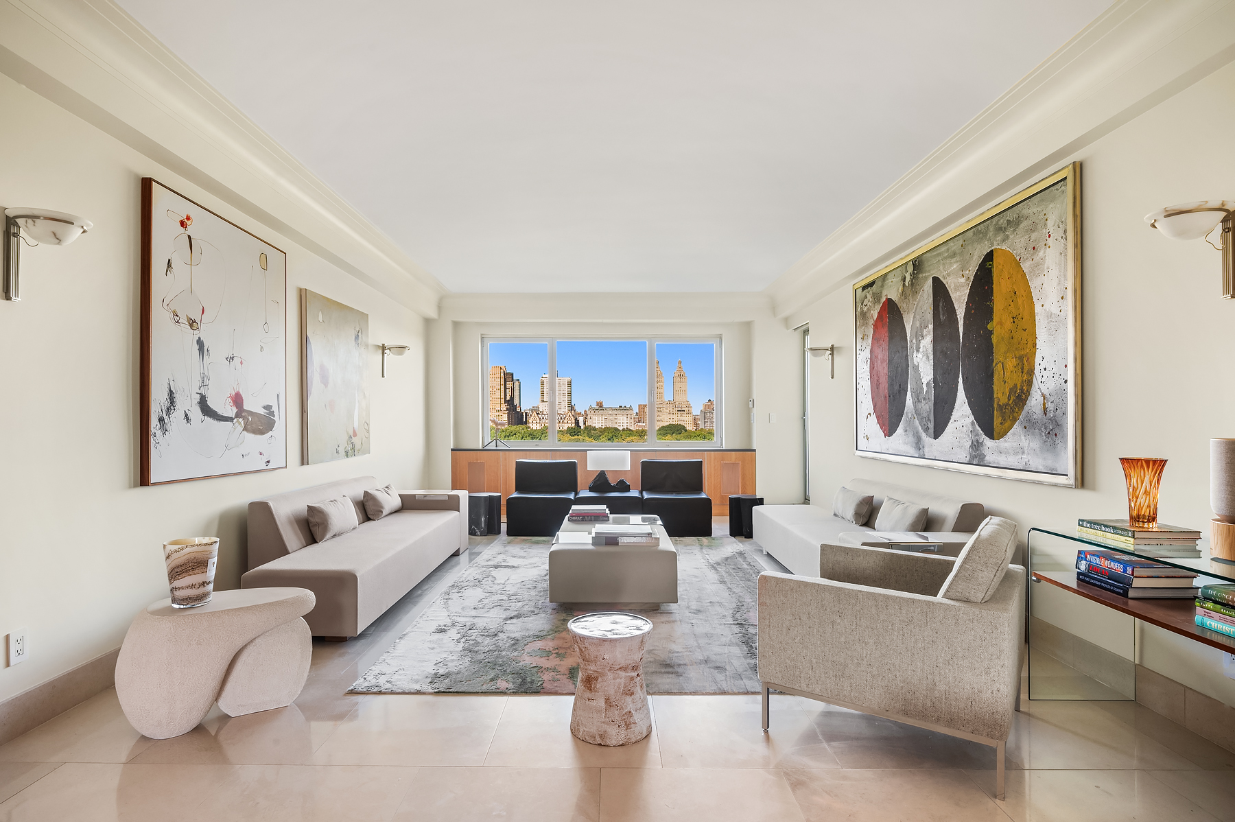 a living room with furniture large window and kitchen view