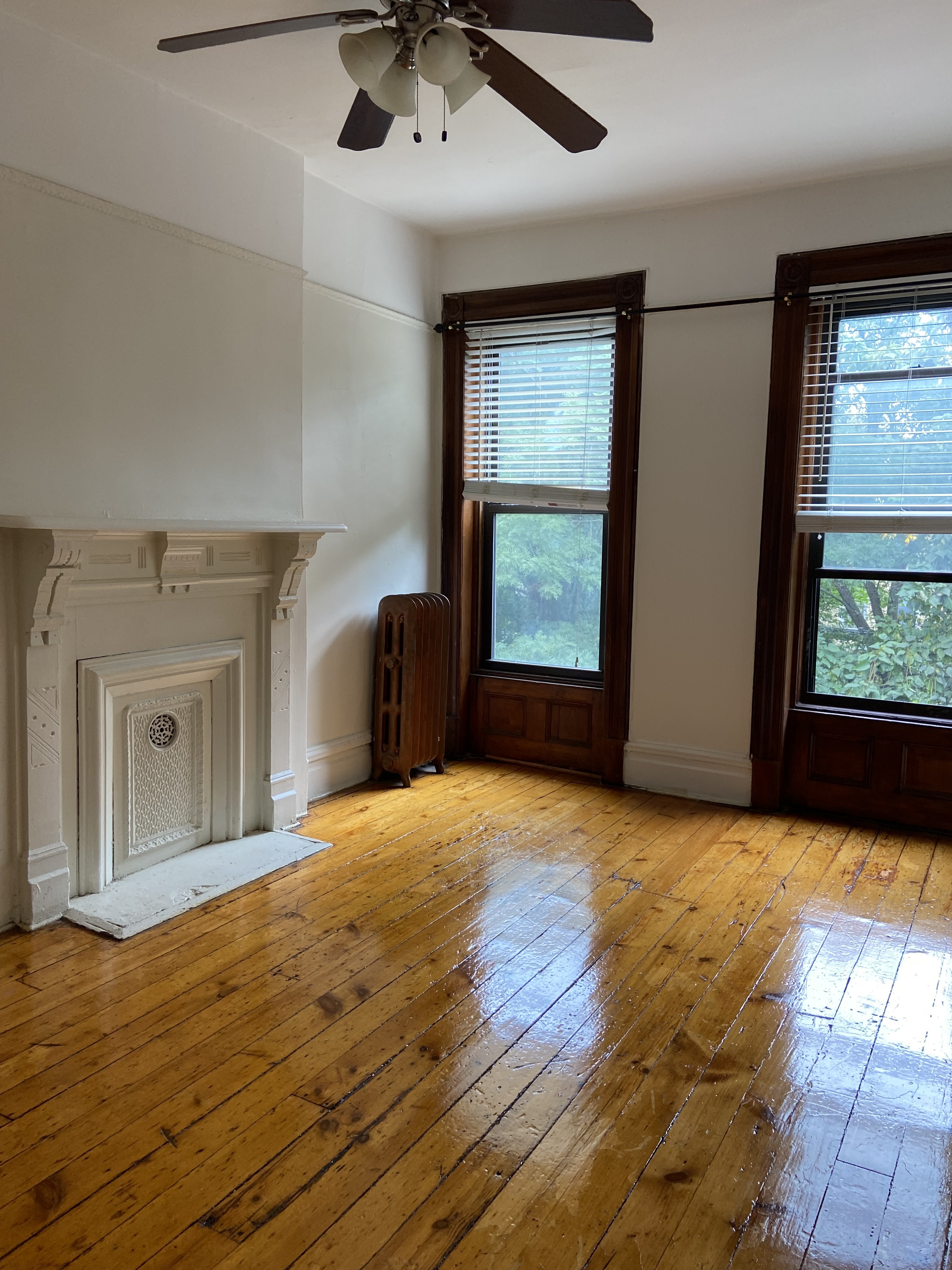 a view of an empty room with window and cabinet