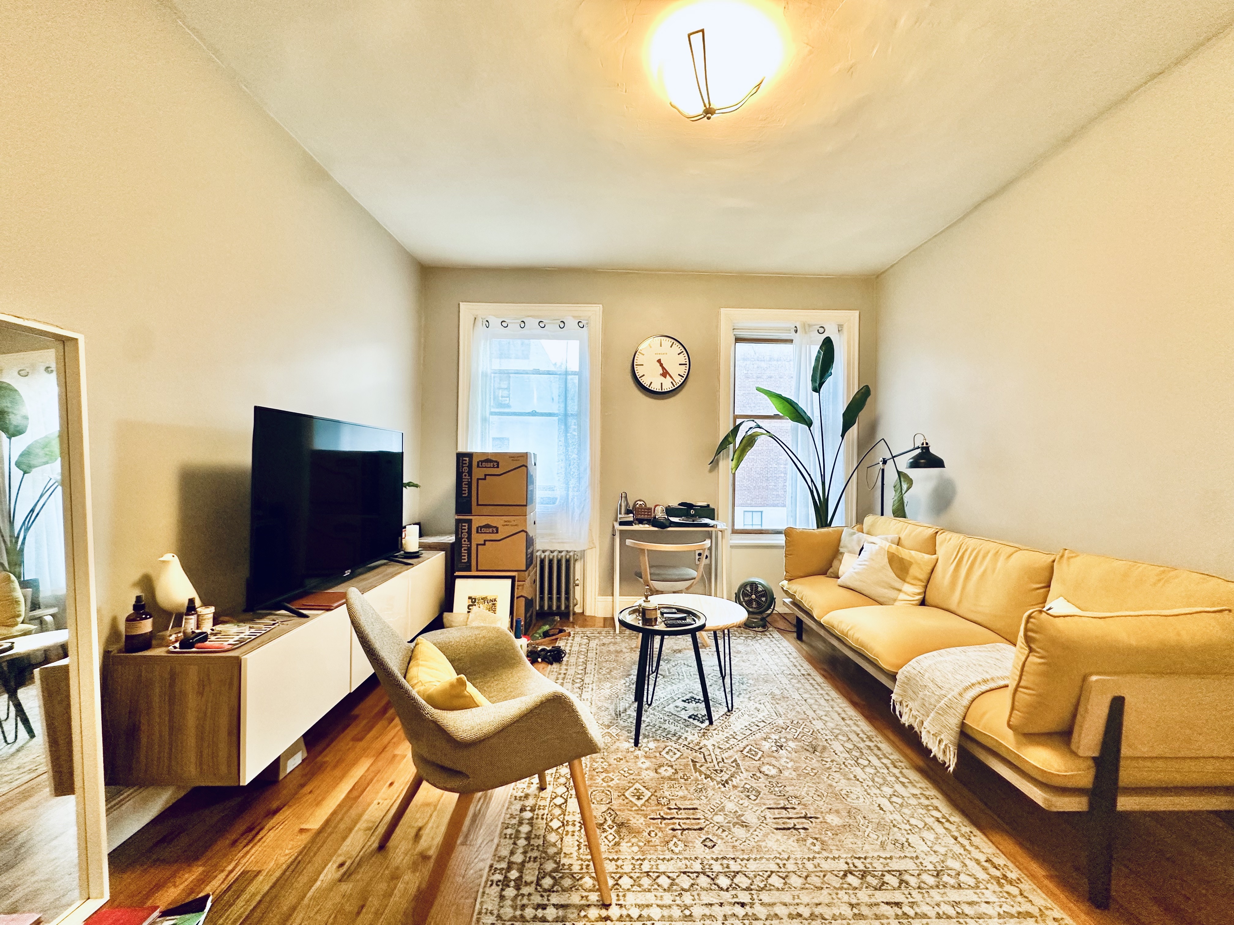 a living room with furniture and wooden floor