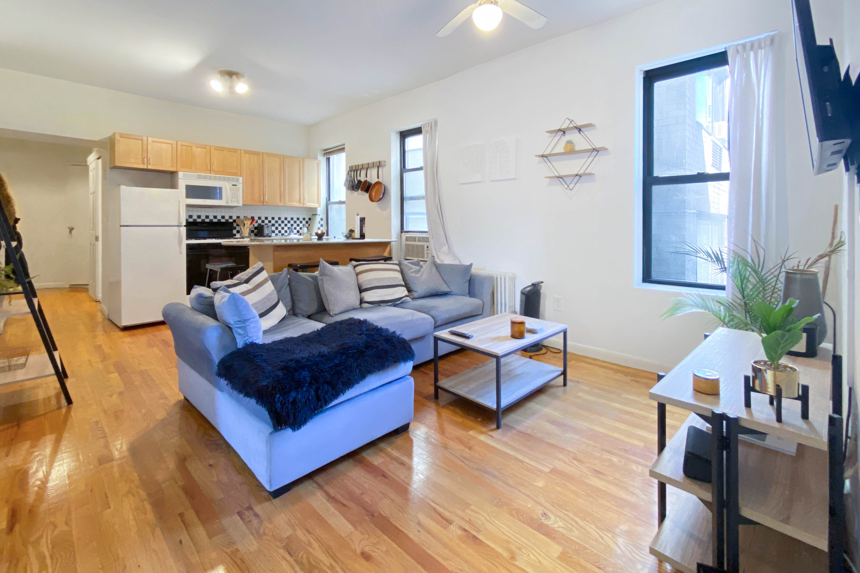 a living room with furniture and a wooden floor