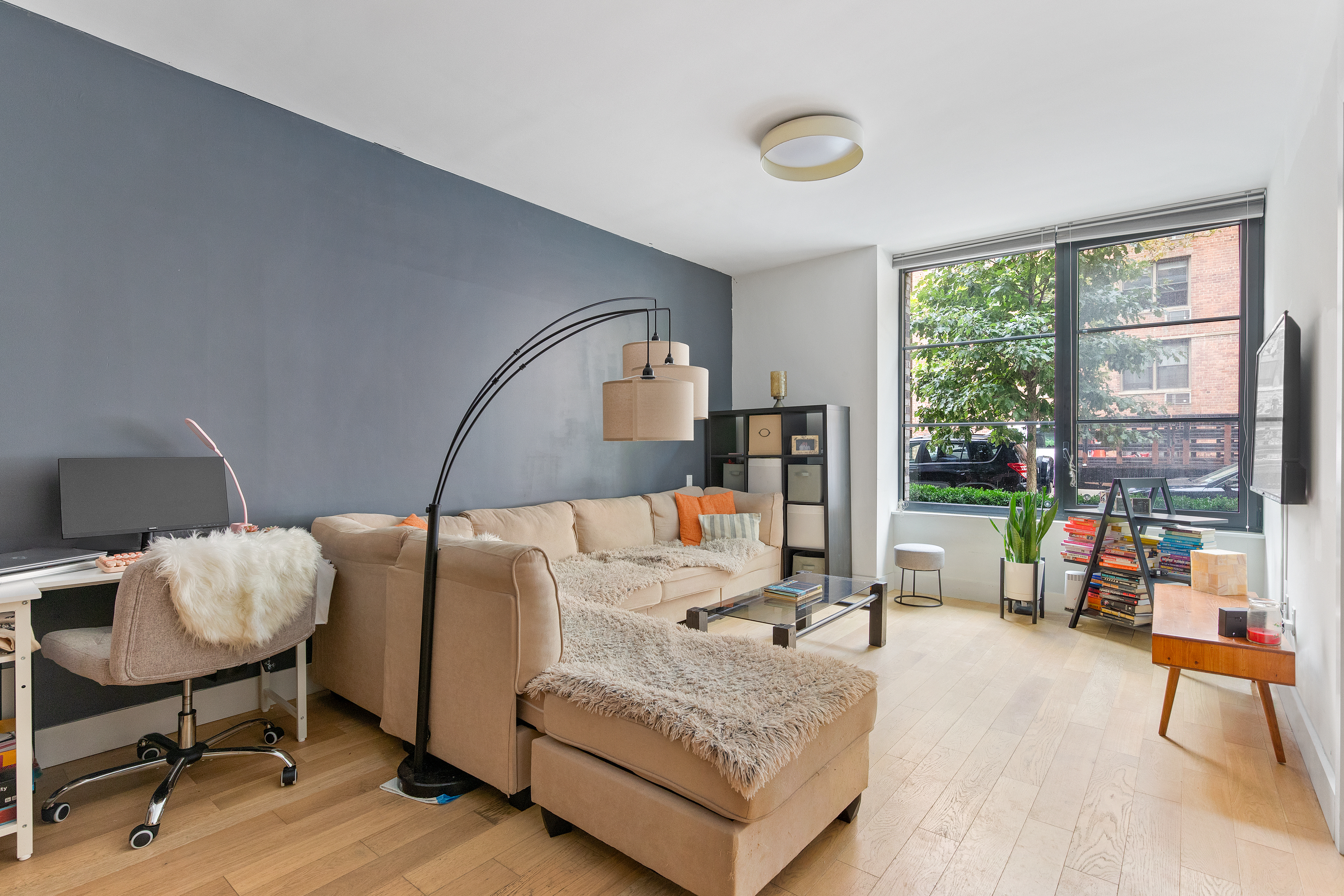 a bedroom with furniture and a large window