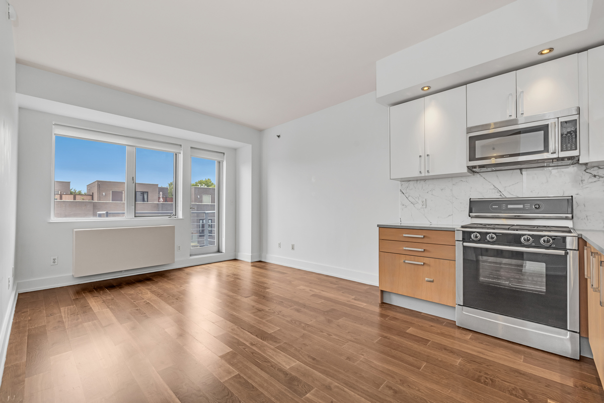 a kitchen with stainless steel appliances a stove microwave and cabinets