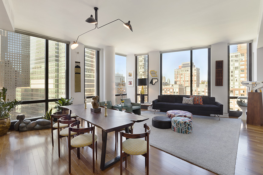 a living room with furniture and large windows