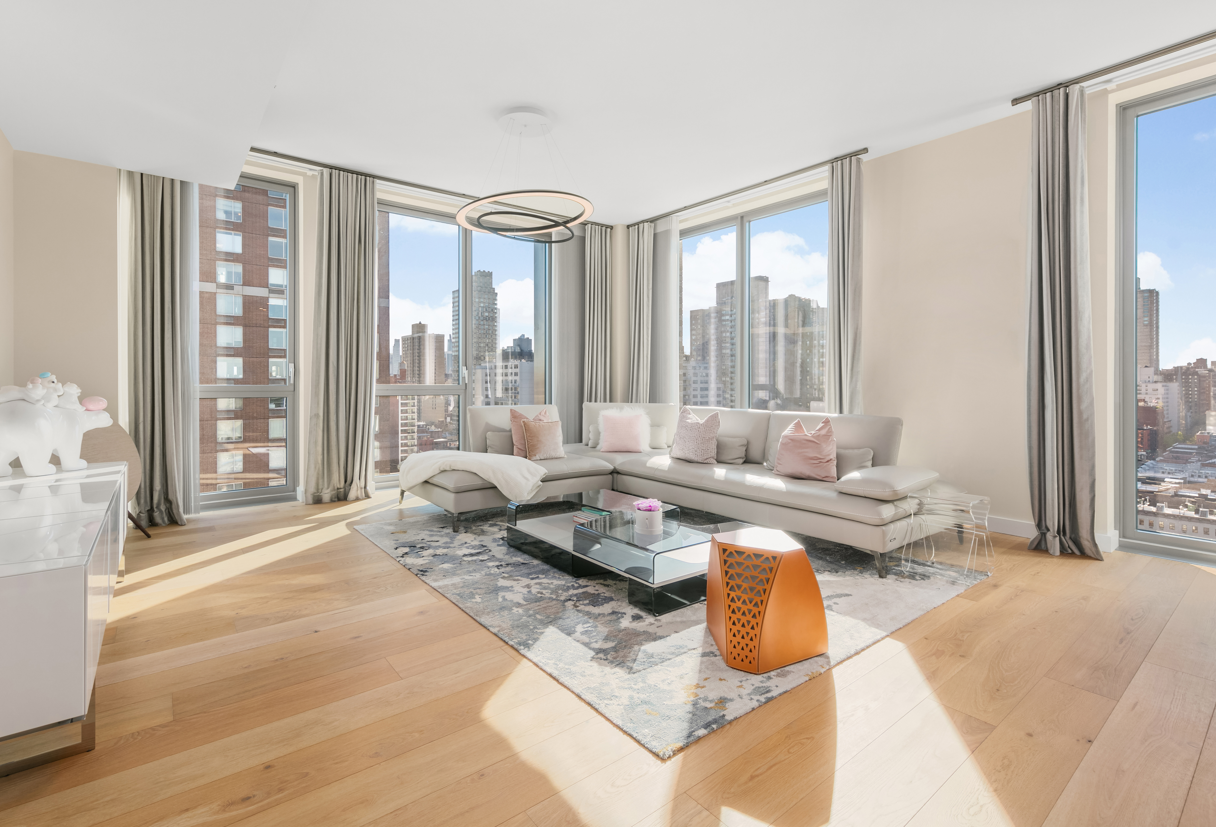 a living room with furniture and large windows