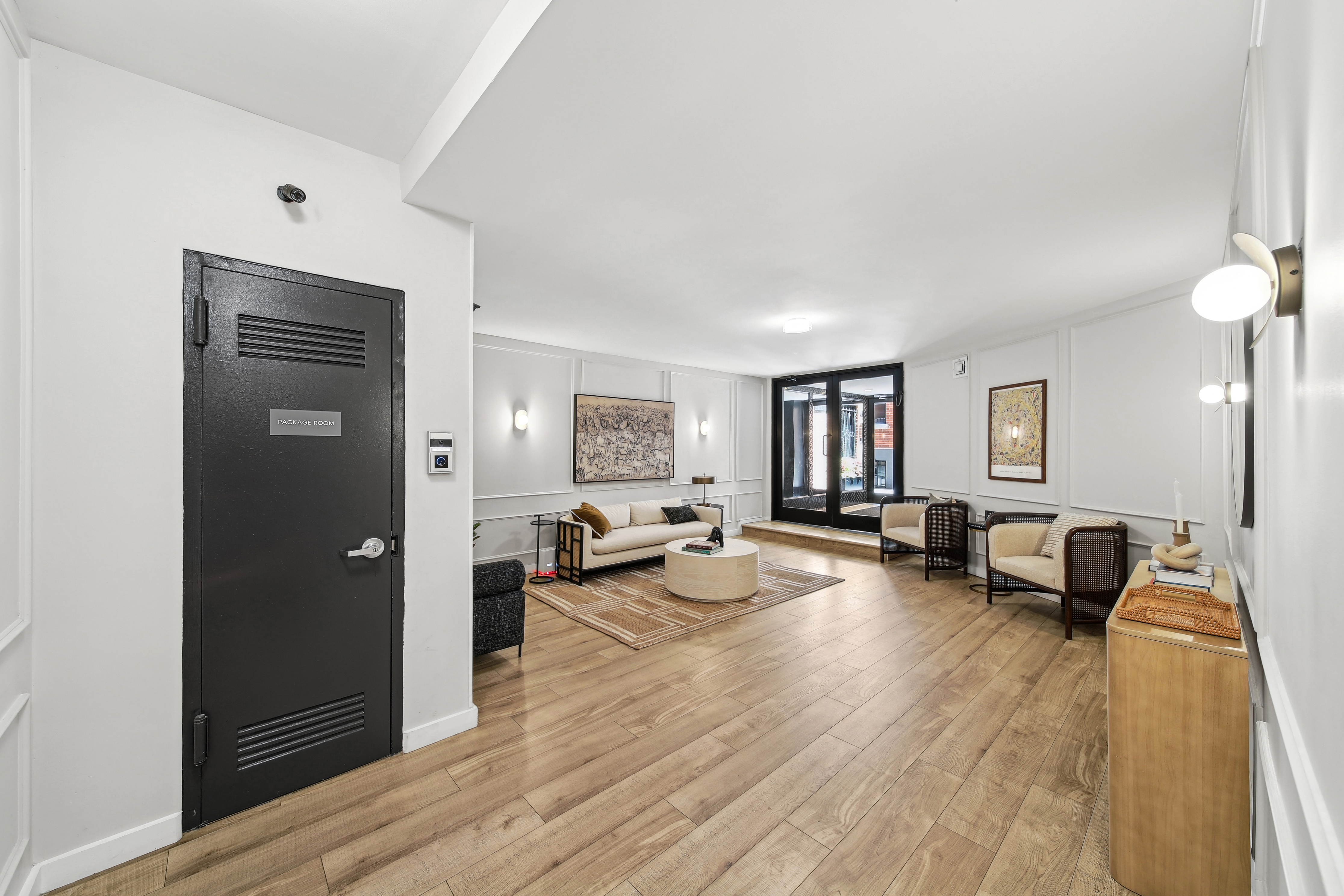 a living room with furniture and a wooden floor