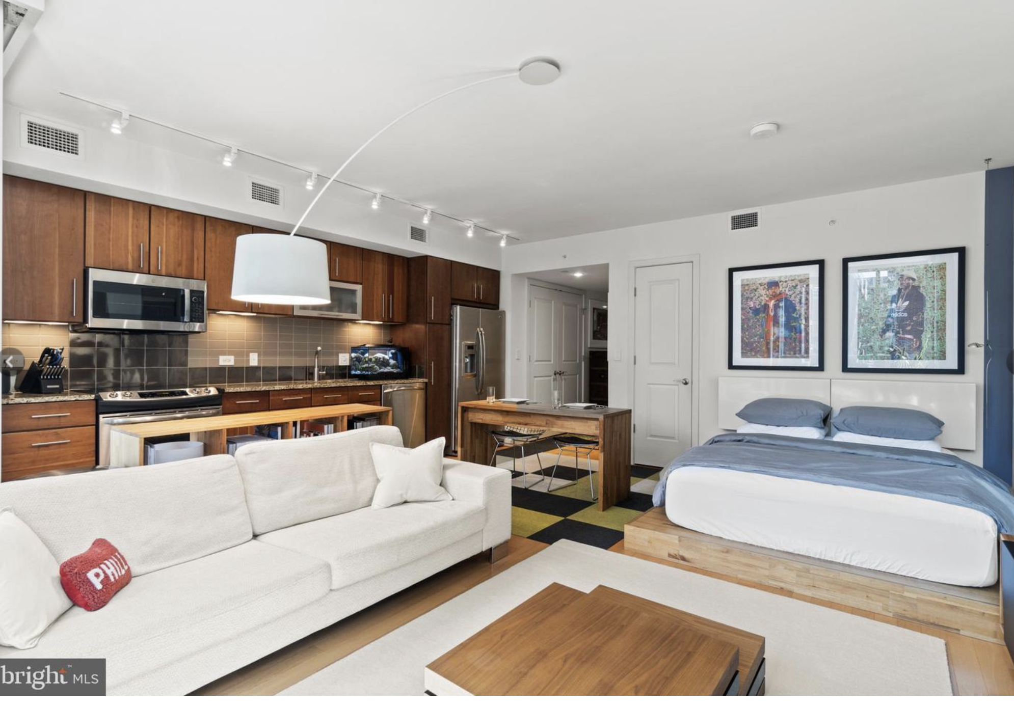 a living room with stainless steel appliances kitchen island granite countertop furniture and a view of kitchen