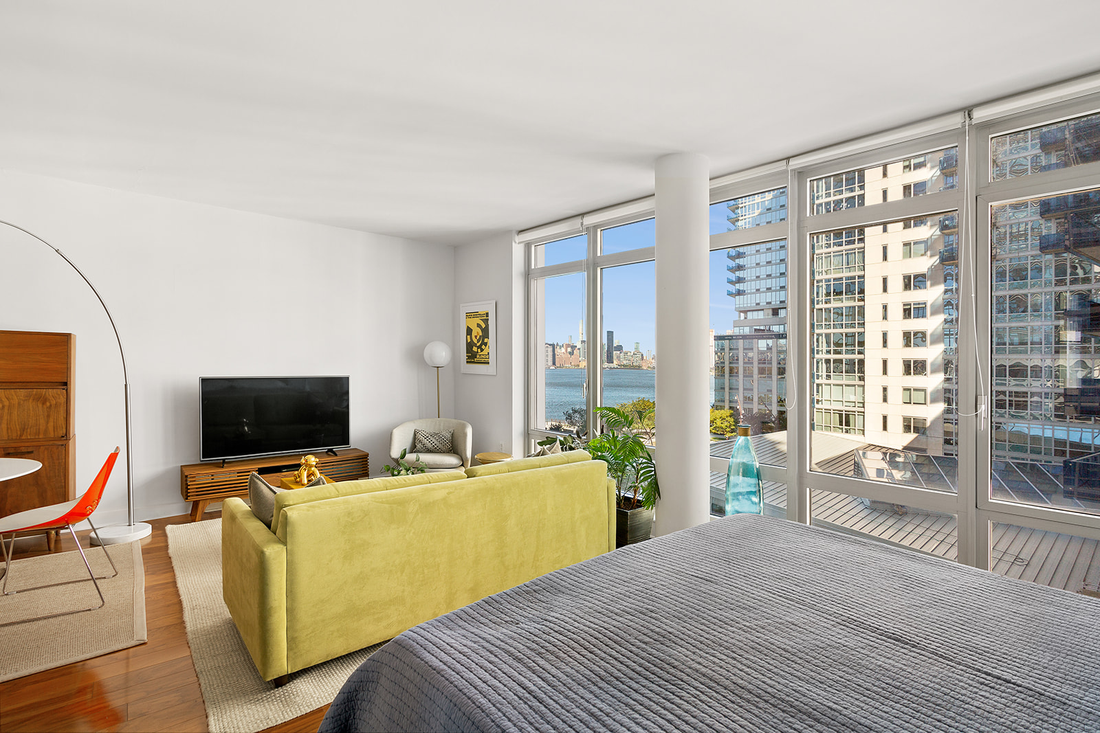 a view of a livingroom with workspace and a window