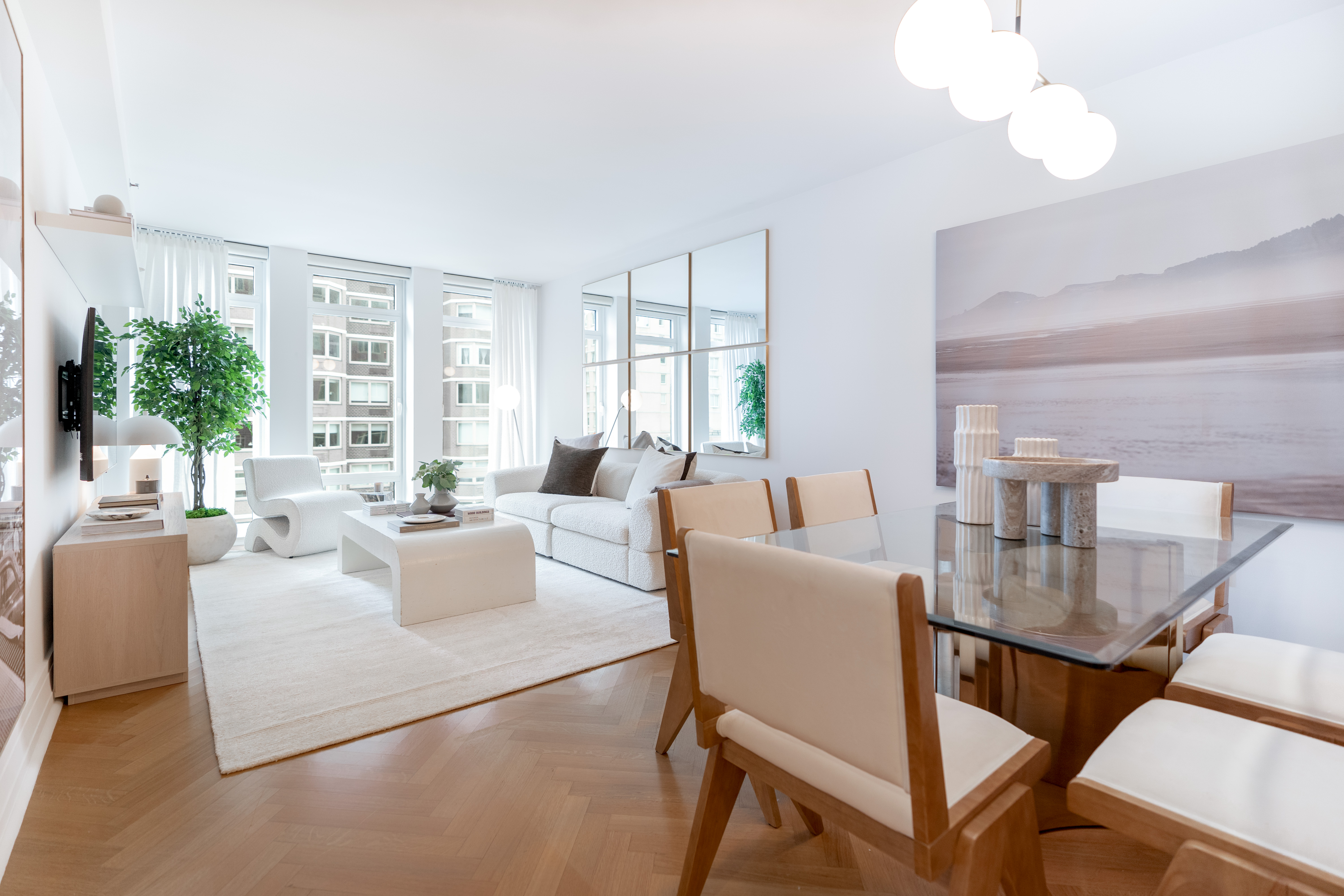 a living room with fireplace furniture and a large window