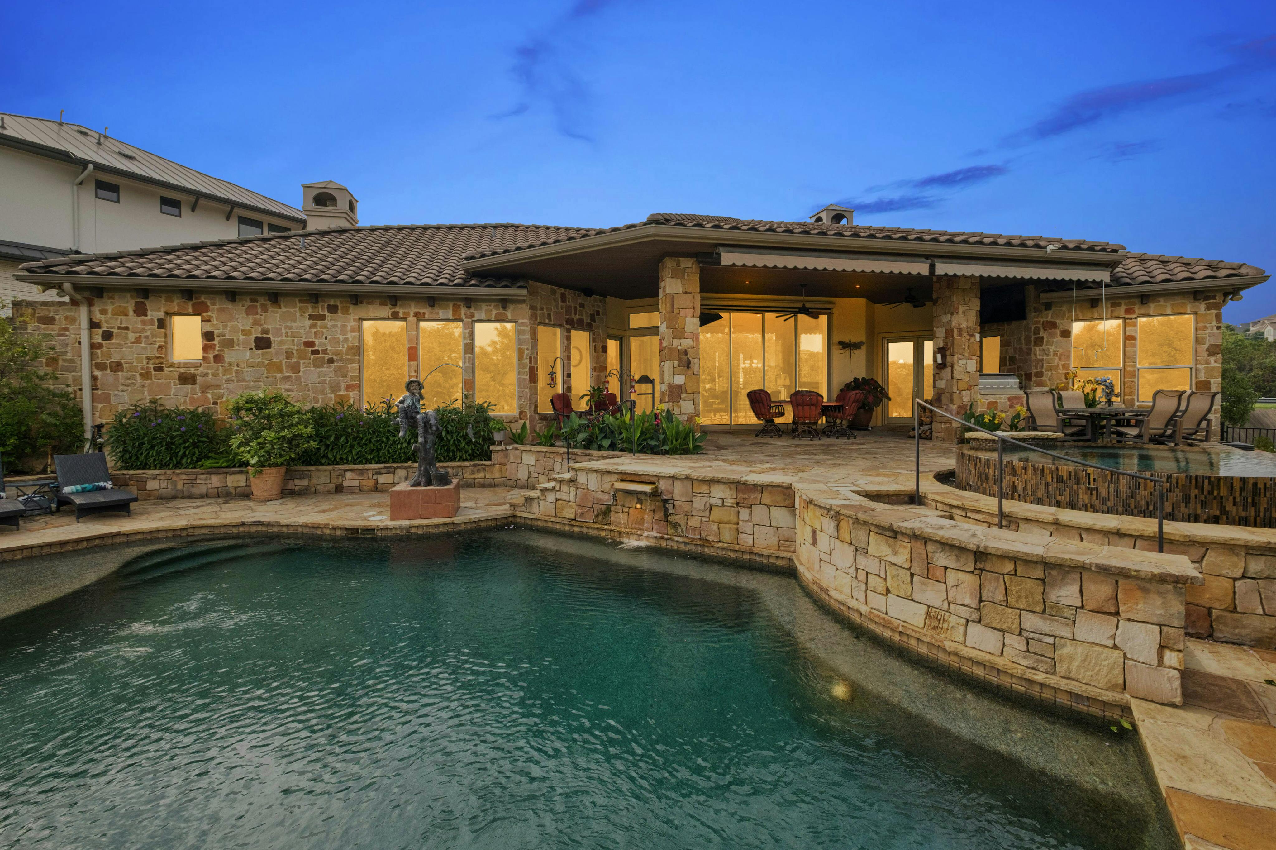 a view of a house with swimming pool and sitting area