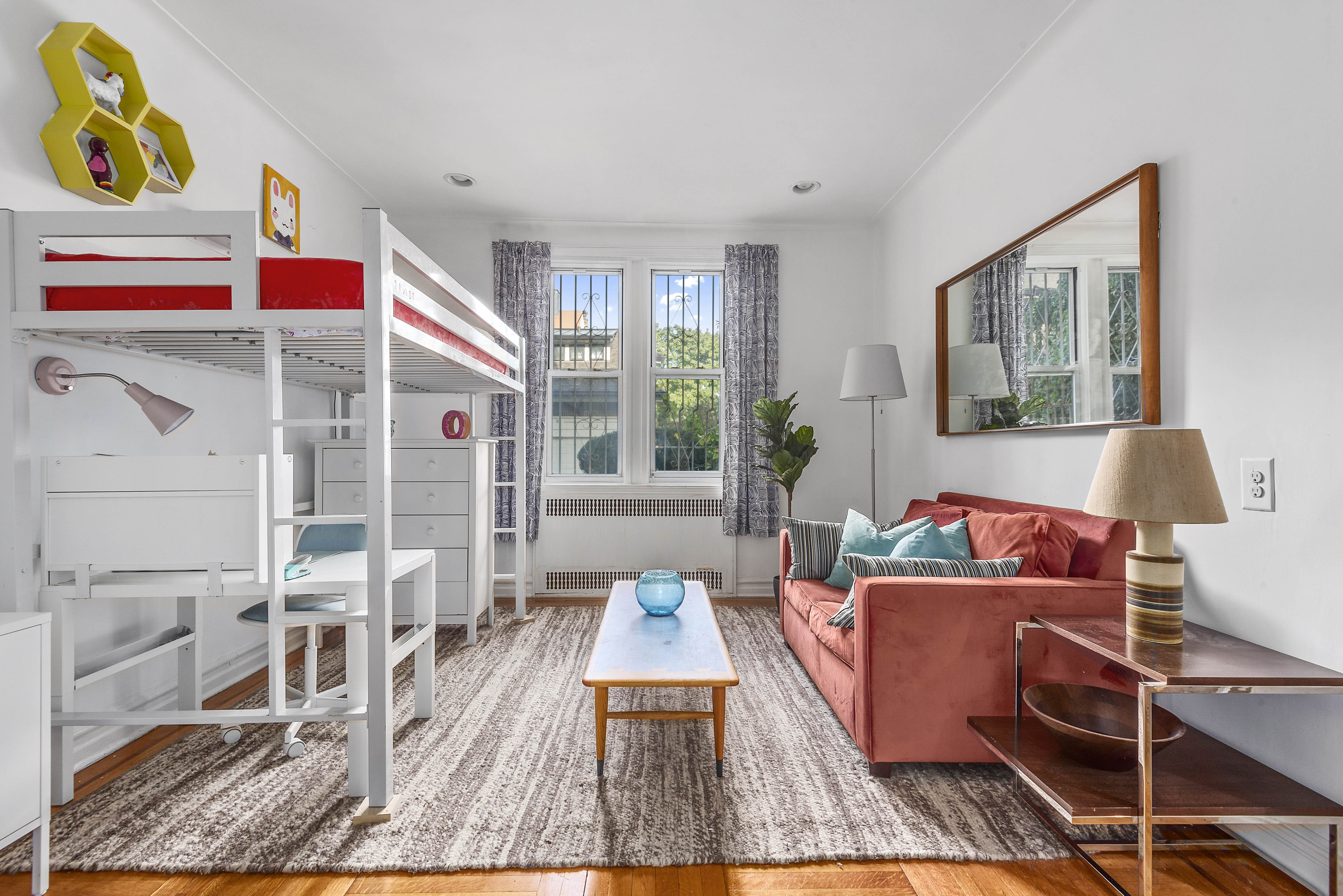 a living room with furniture and a lamp