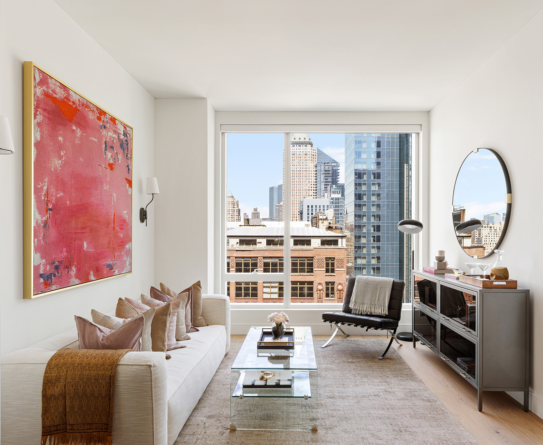 a living room with furniture and a floor to ceiling window