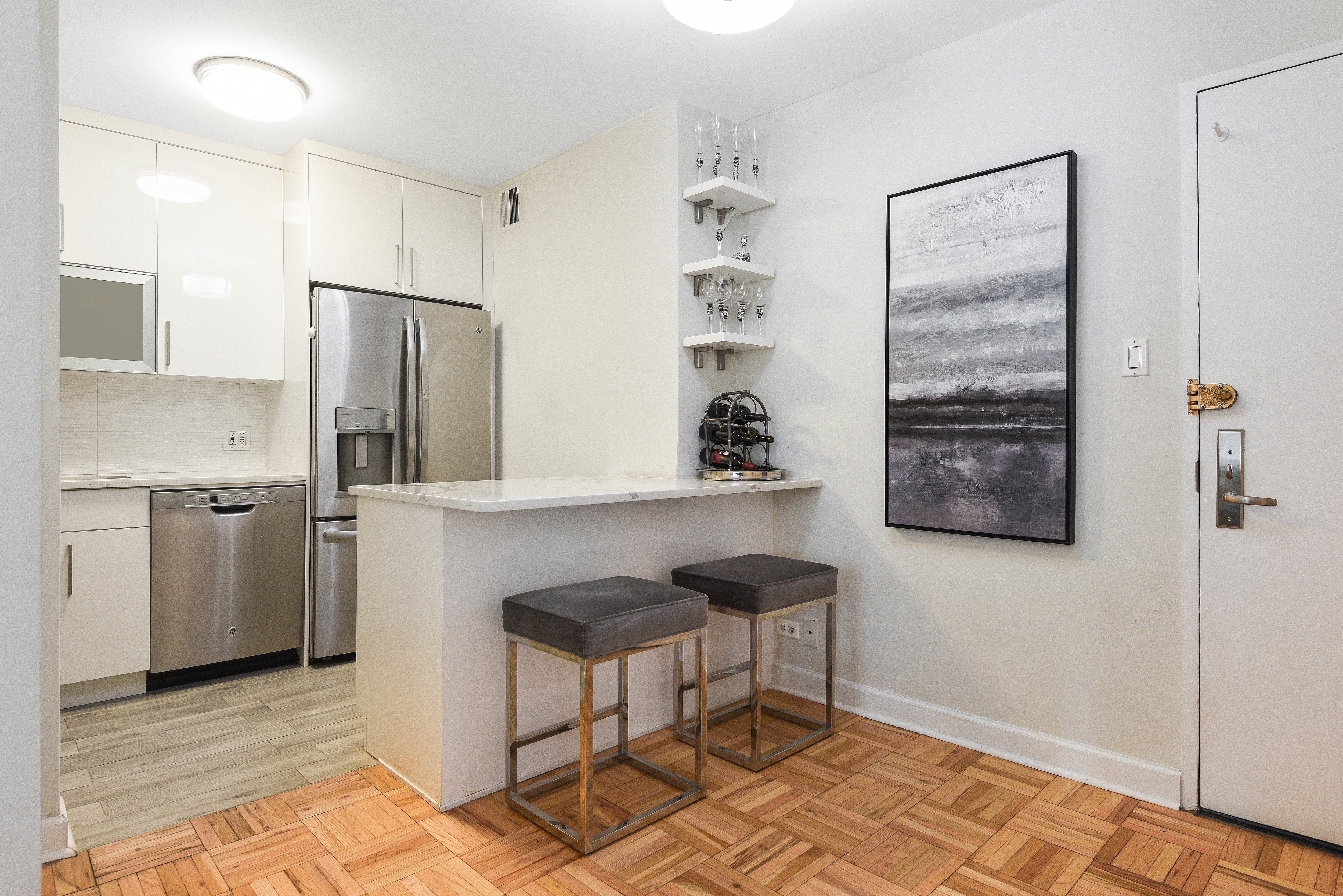 a kitchen with stainless steel appliances granite countertop a refrigerator and a stove