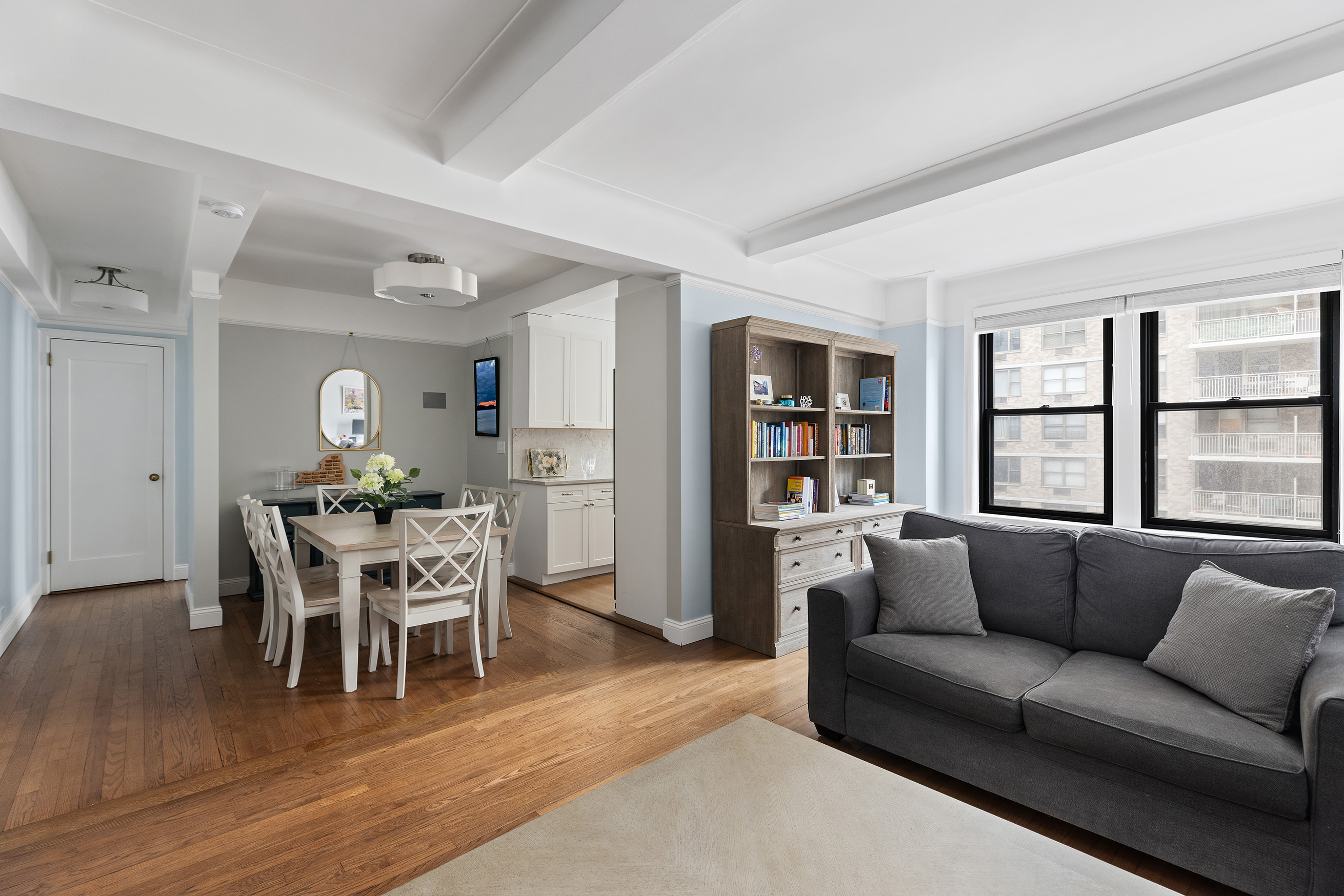 a living room with furniture and wooden floor