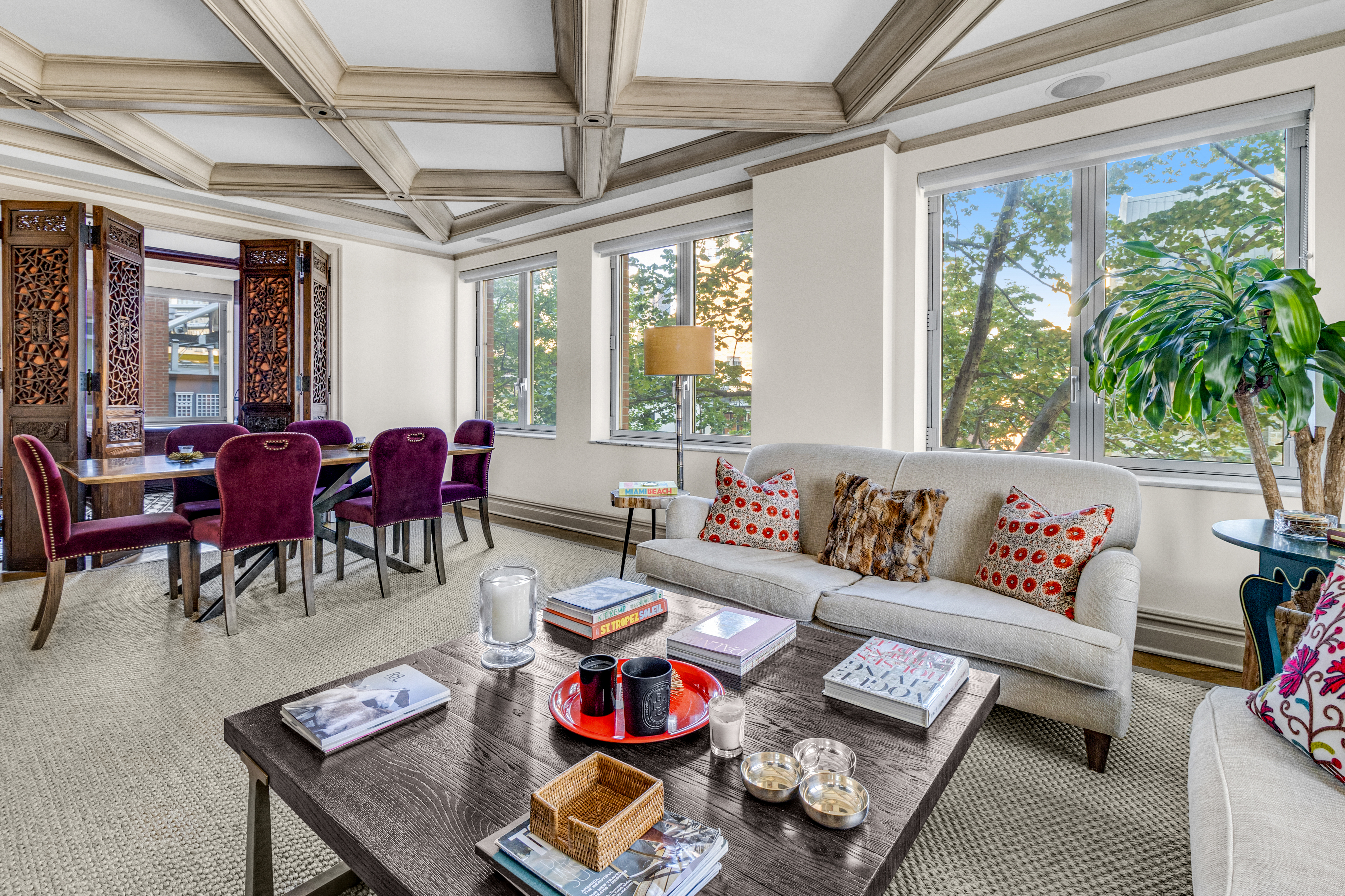 a living room with furniture and floor to ceiling windows