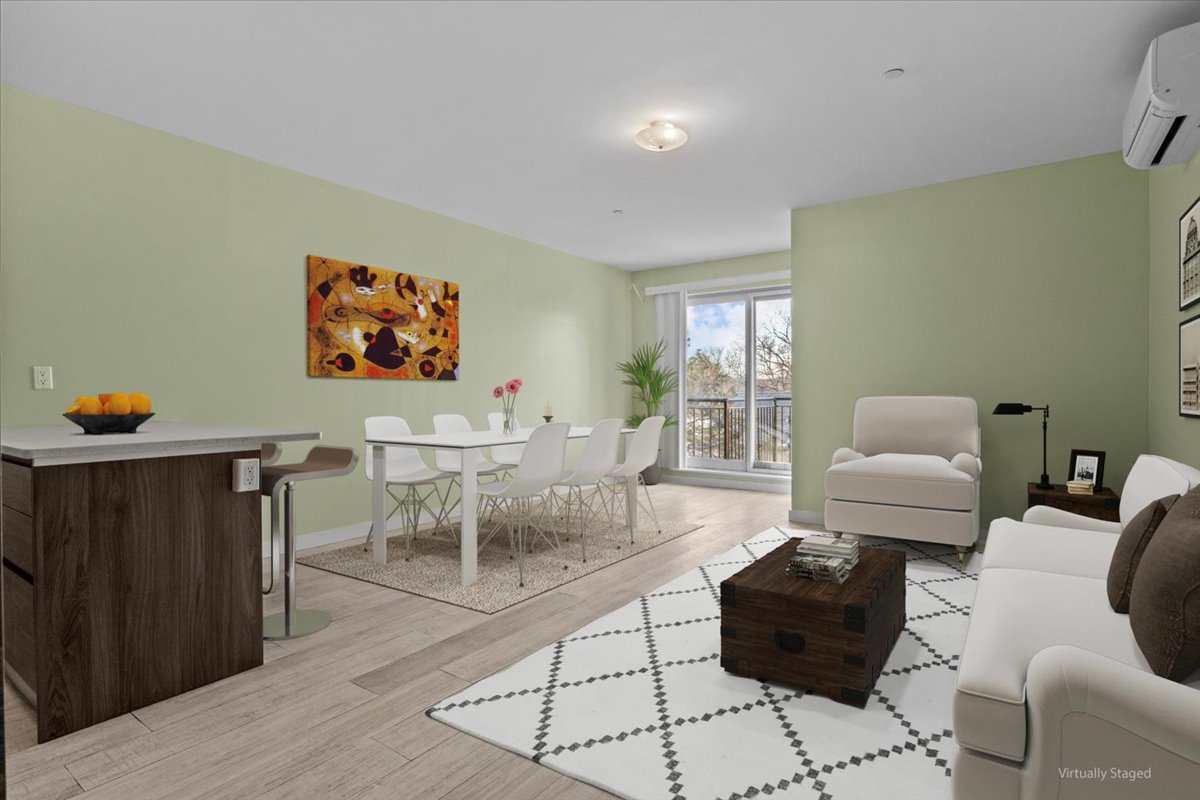 a living room with furniture and a painting on the wall