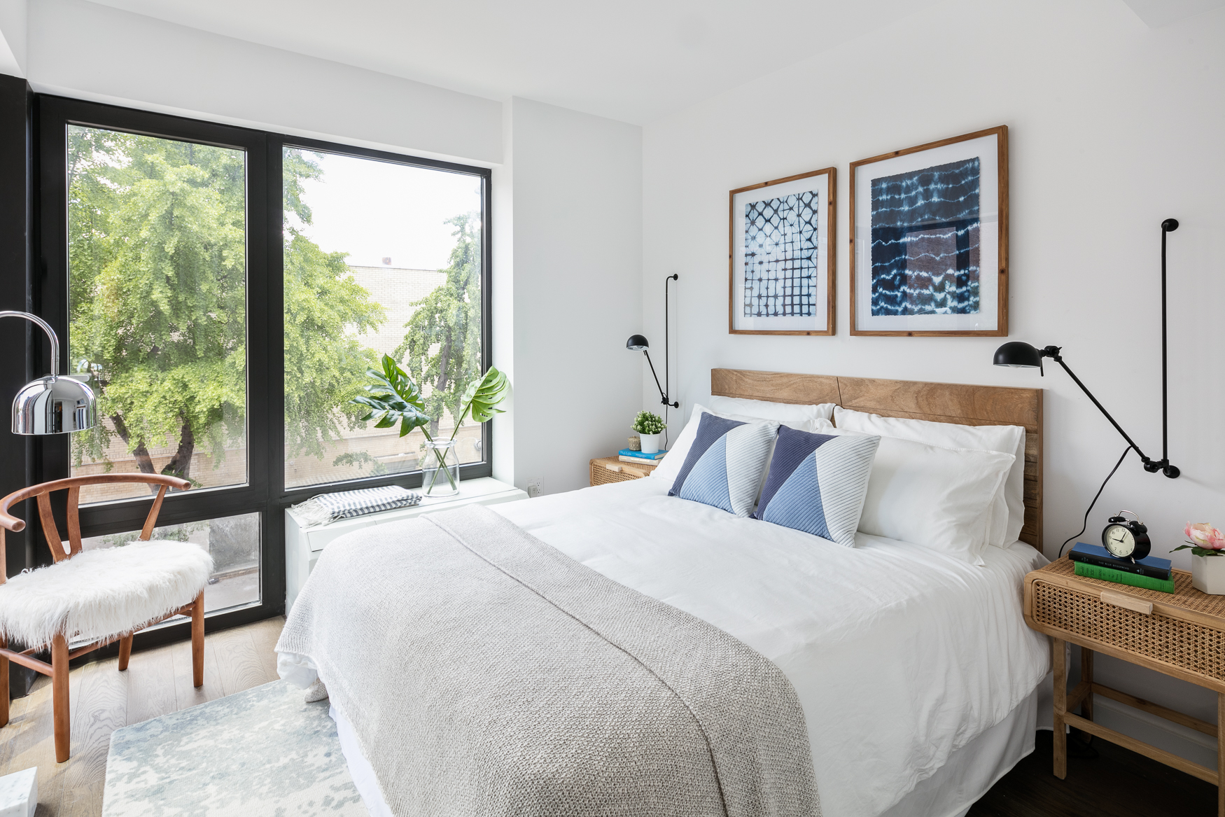 a bedroom with a bed and a large window