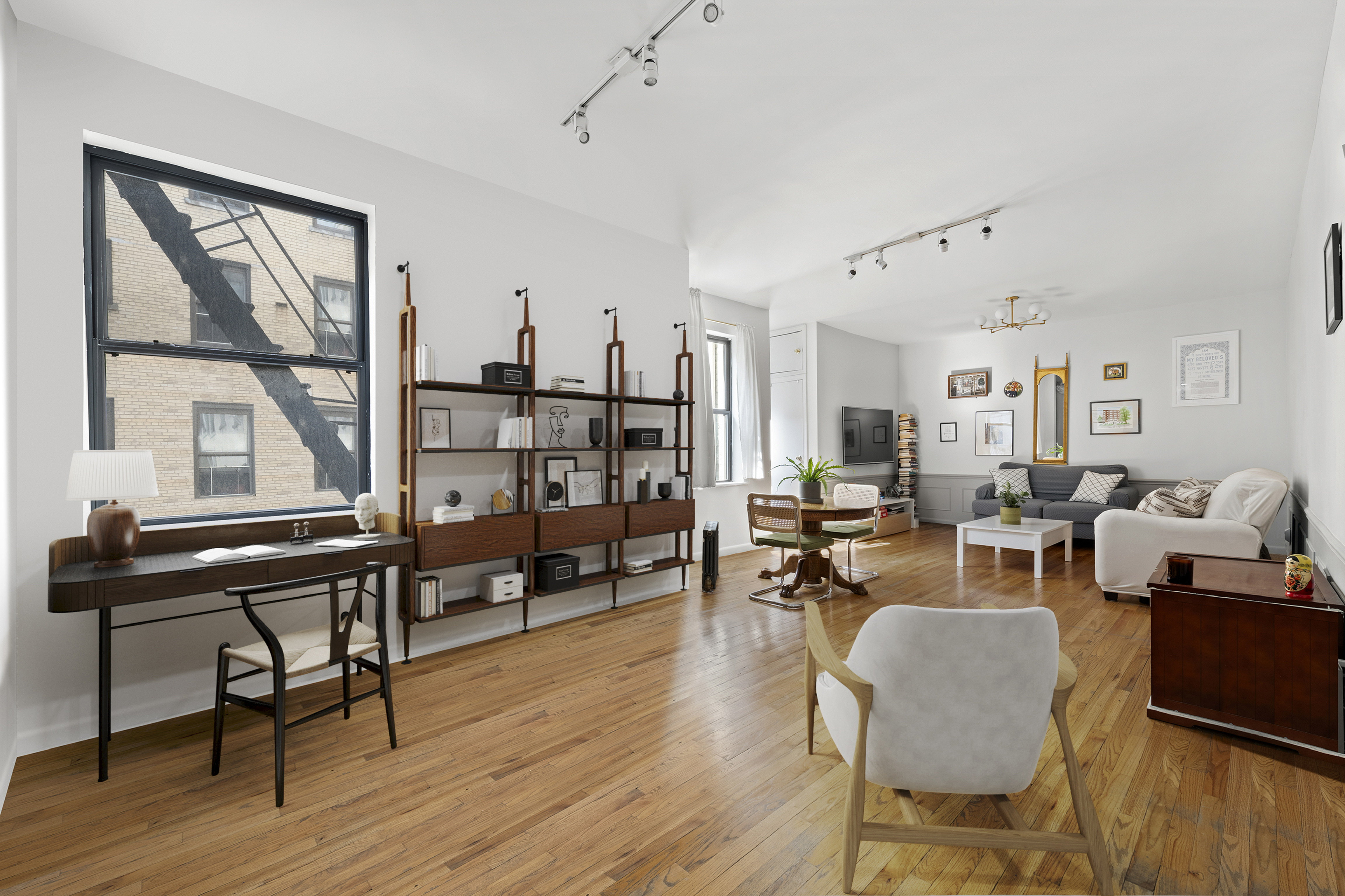 a living room with furniture a wooden floor and a window