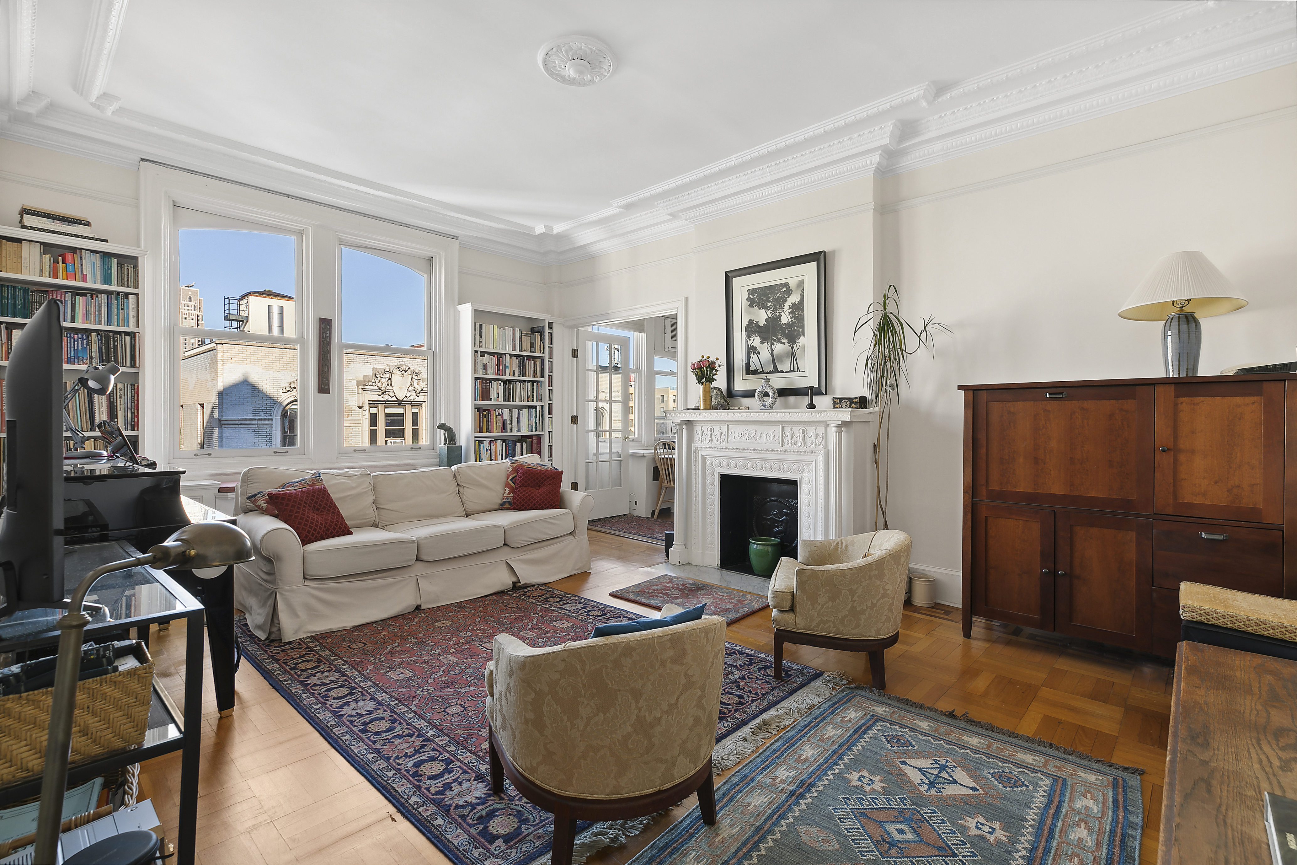 a living room with furniture a rug and a fireplace