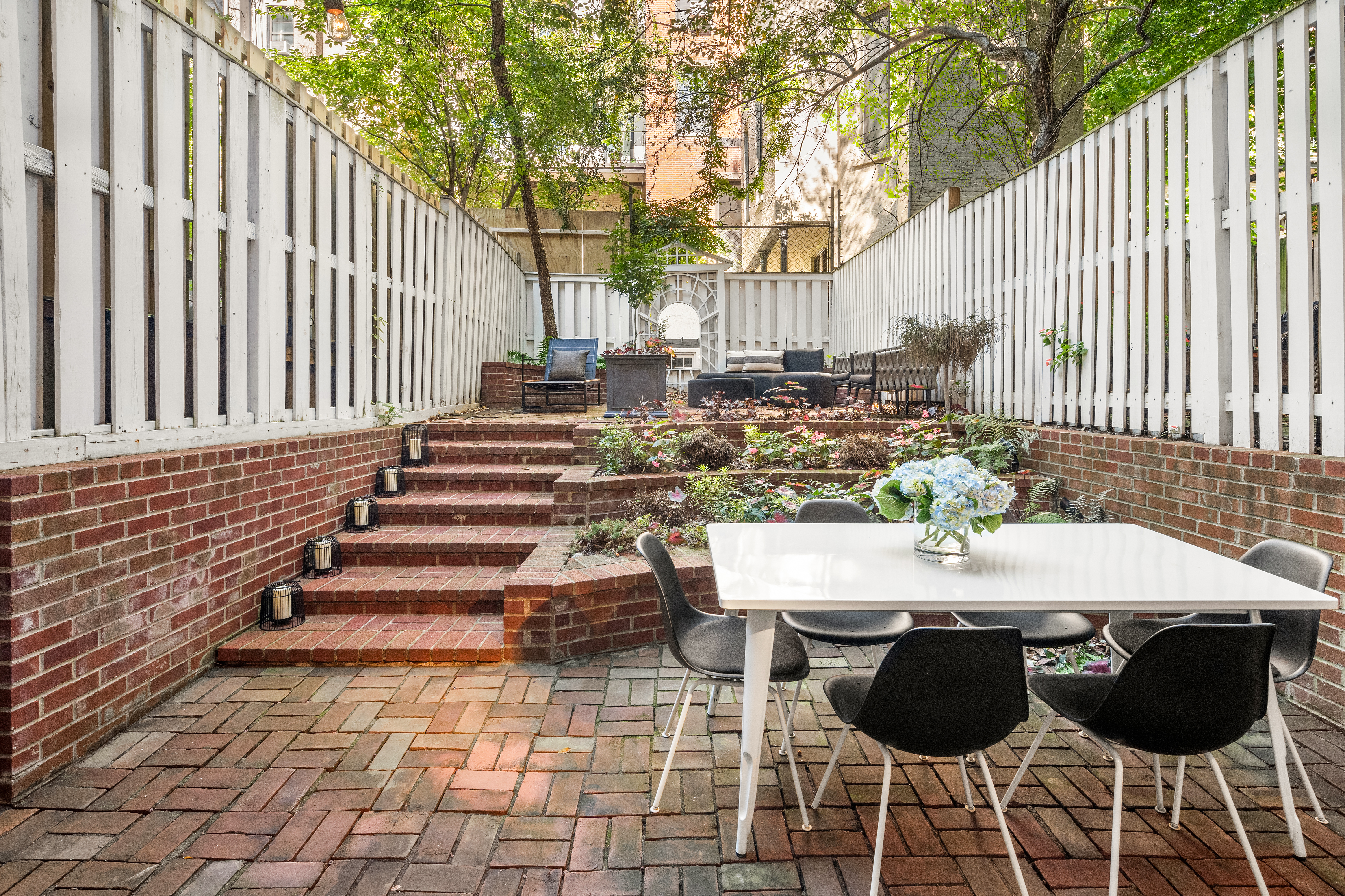 a view of a patio with table and chairs