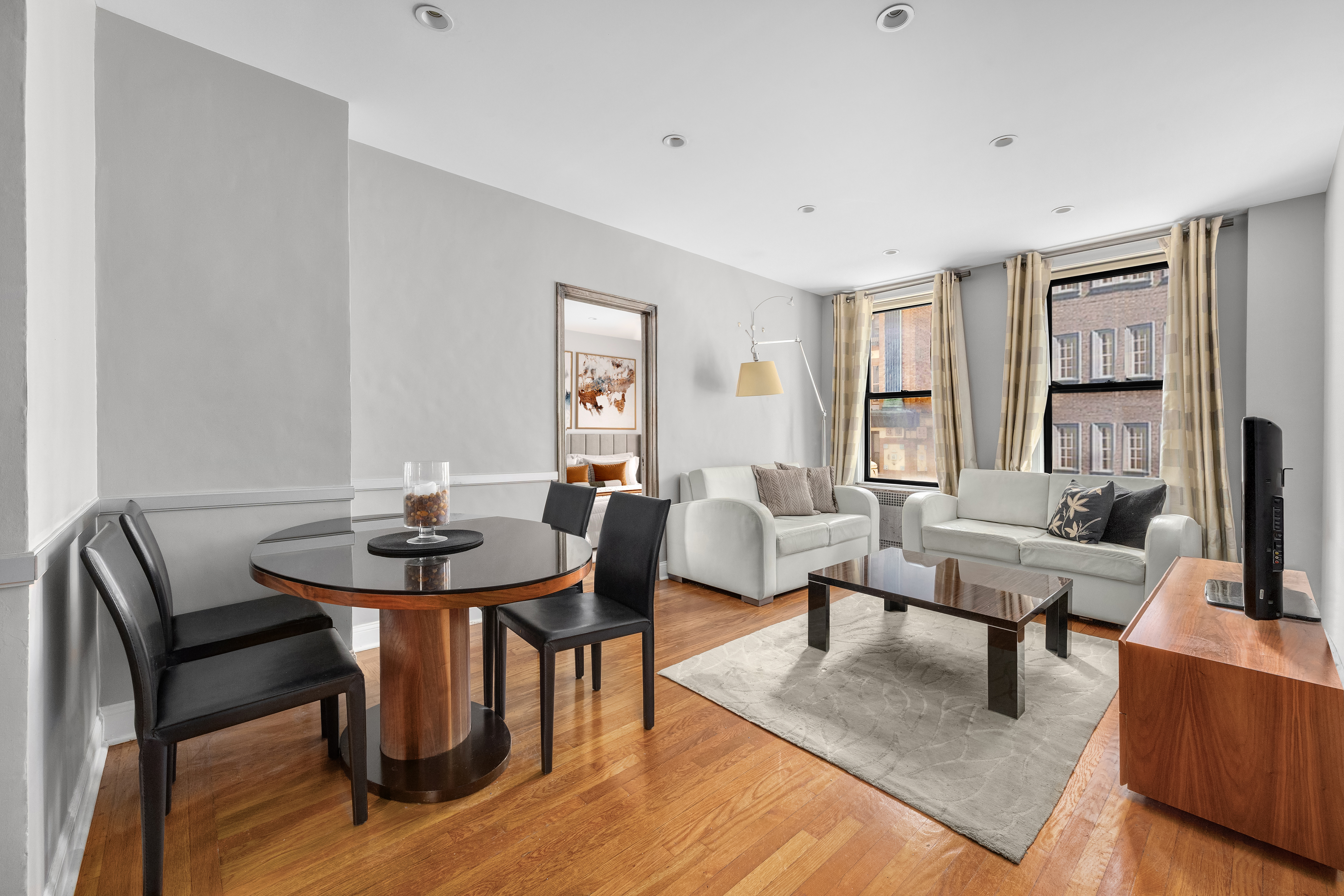 a living room with furniture and wooden floor