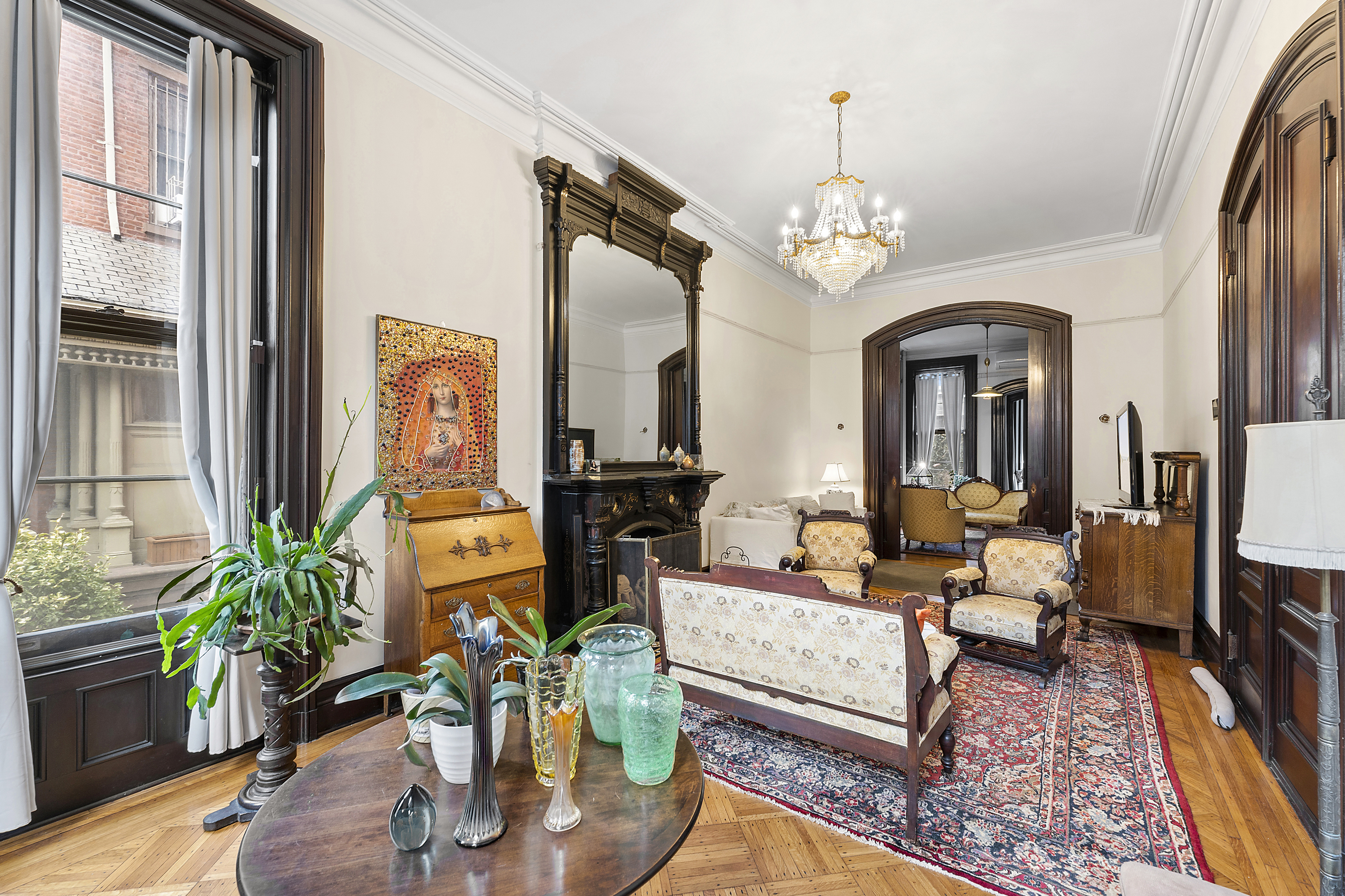 a living room with patio furniture dining table and a chandelier