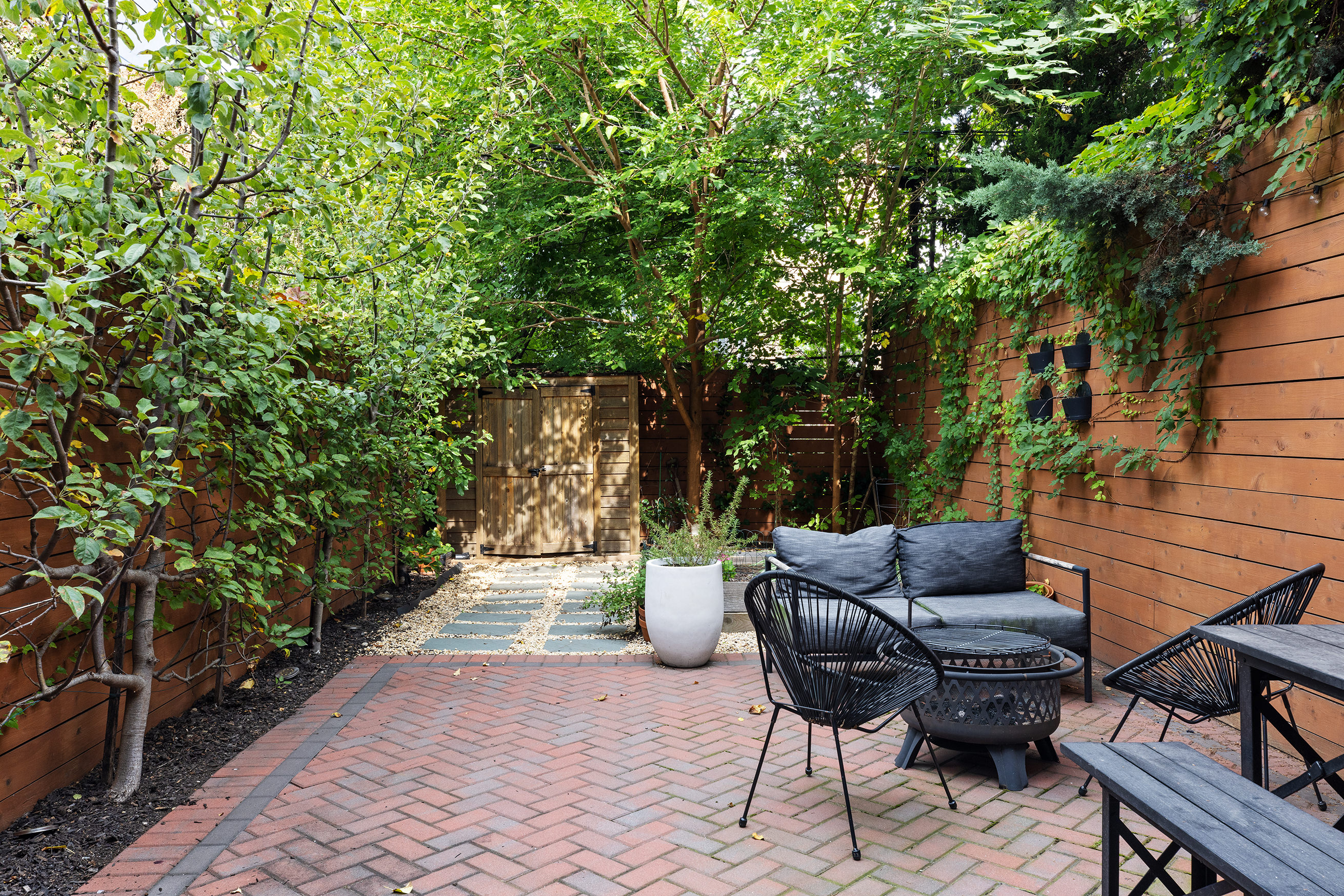 a view of a chairs and table in the backyard