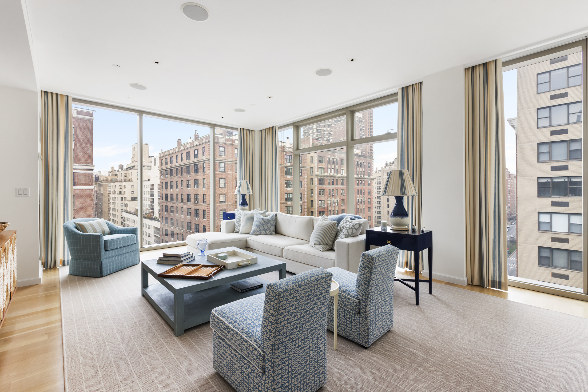 a living room with furniture and a floor to ceiling window