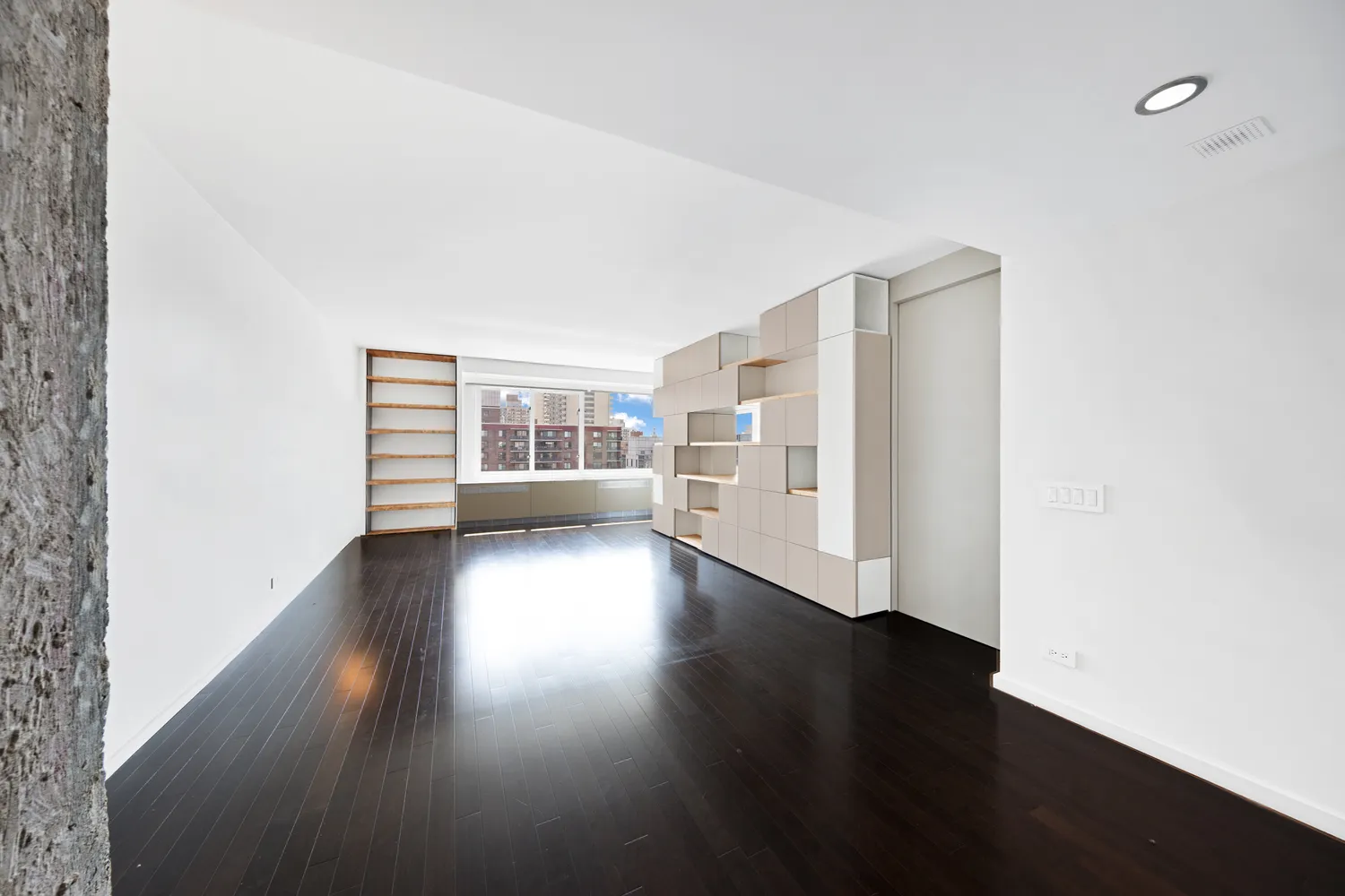 a view of wooden floor and windows in a room