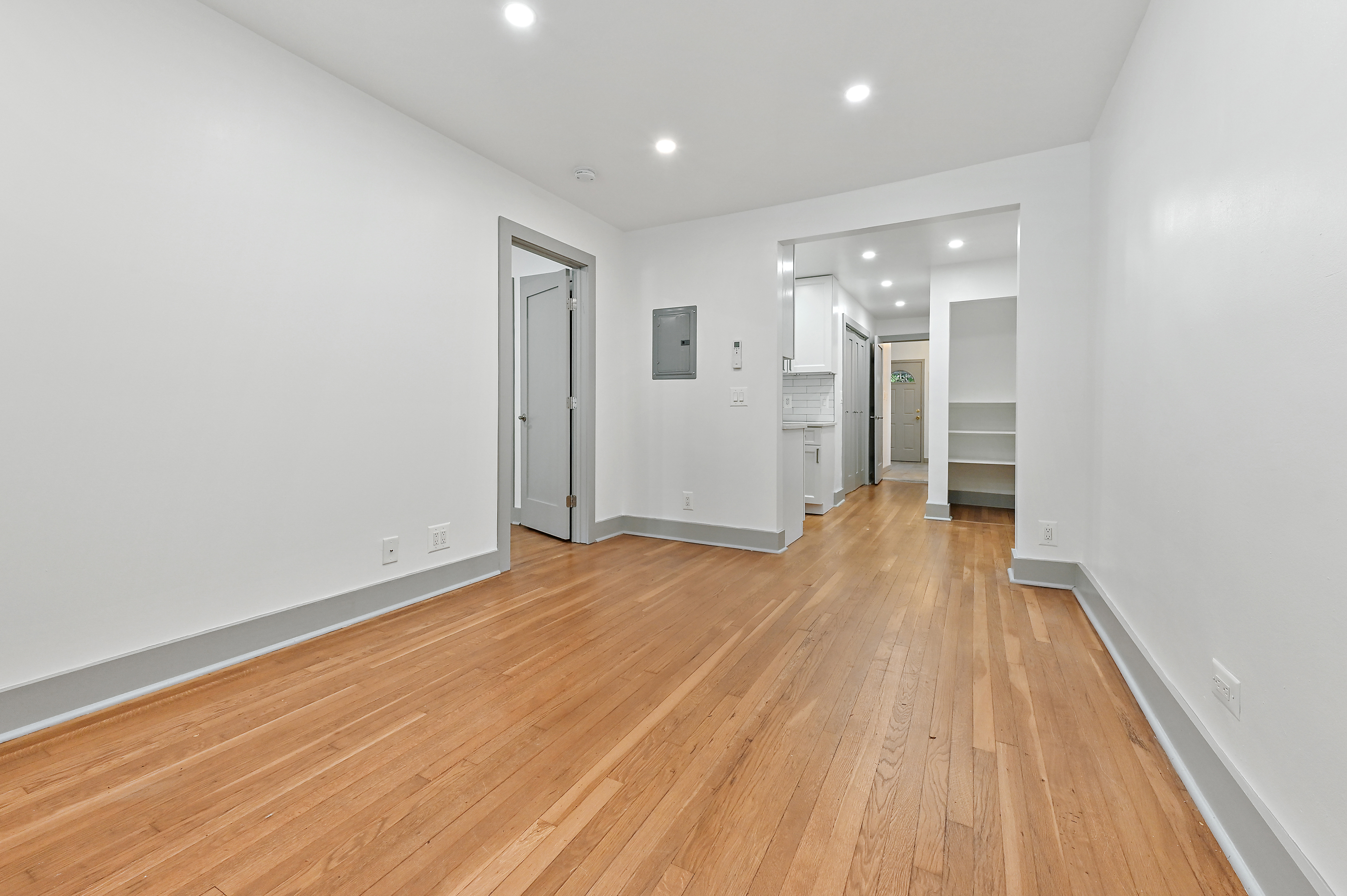 a view of an empty room with wooden floor