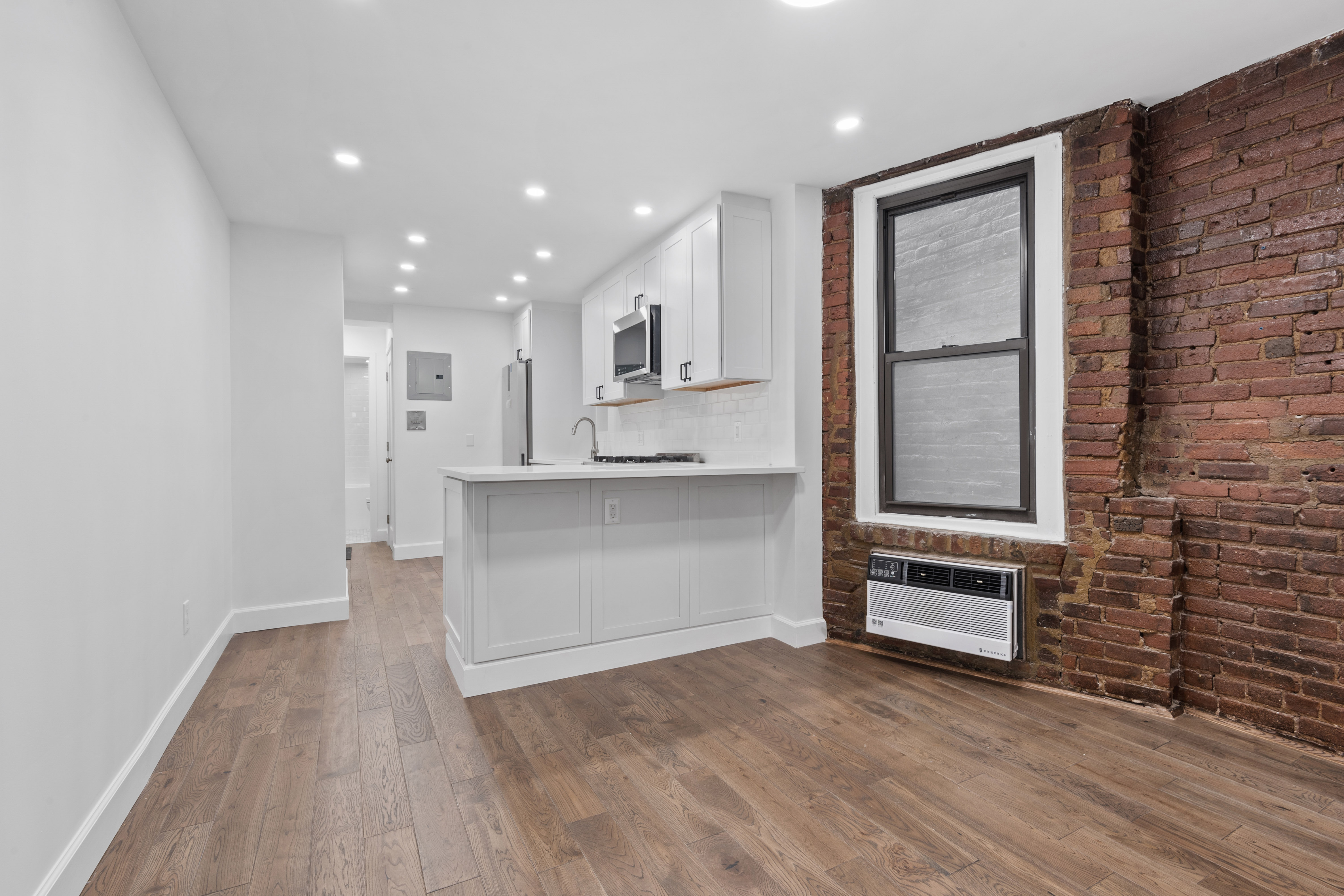 a view of kitchen with wooden floor and electronic appliances