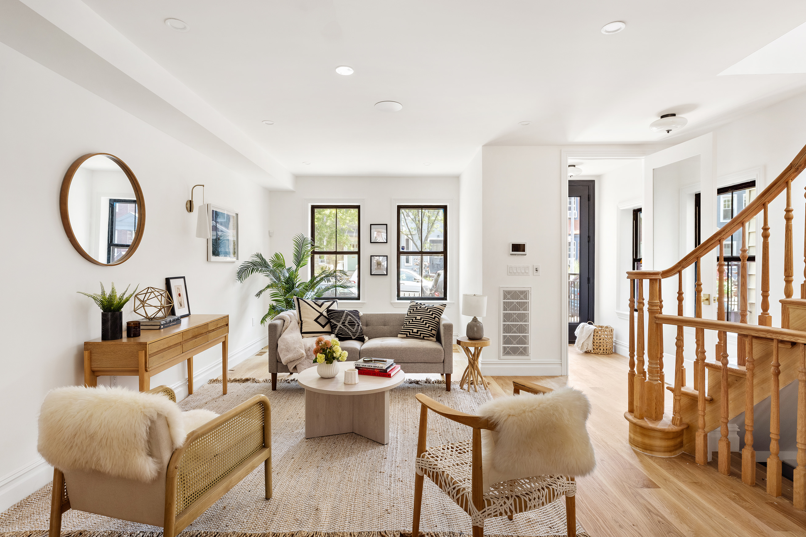 a living room with furniture a fireplace and a large window