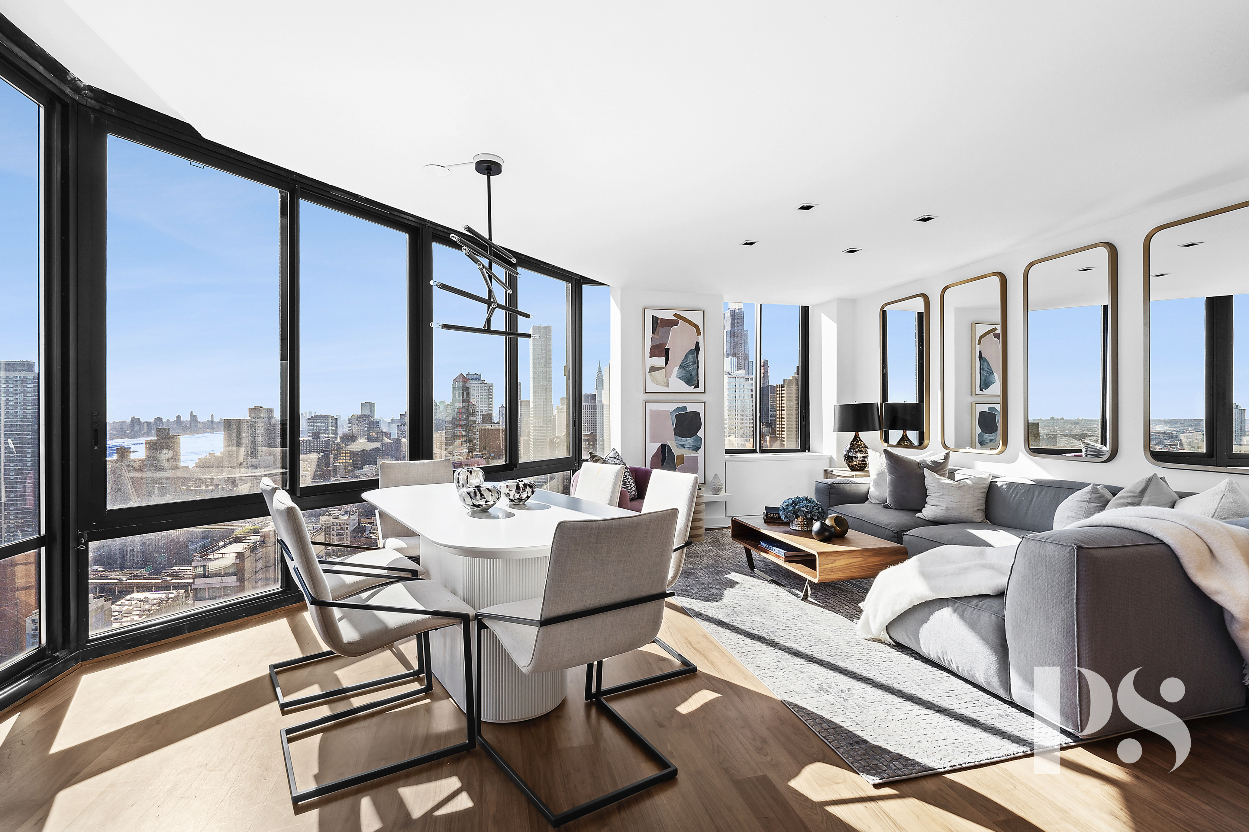 a living room with furniture and large windows