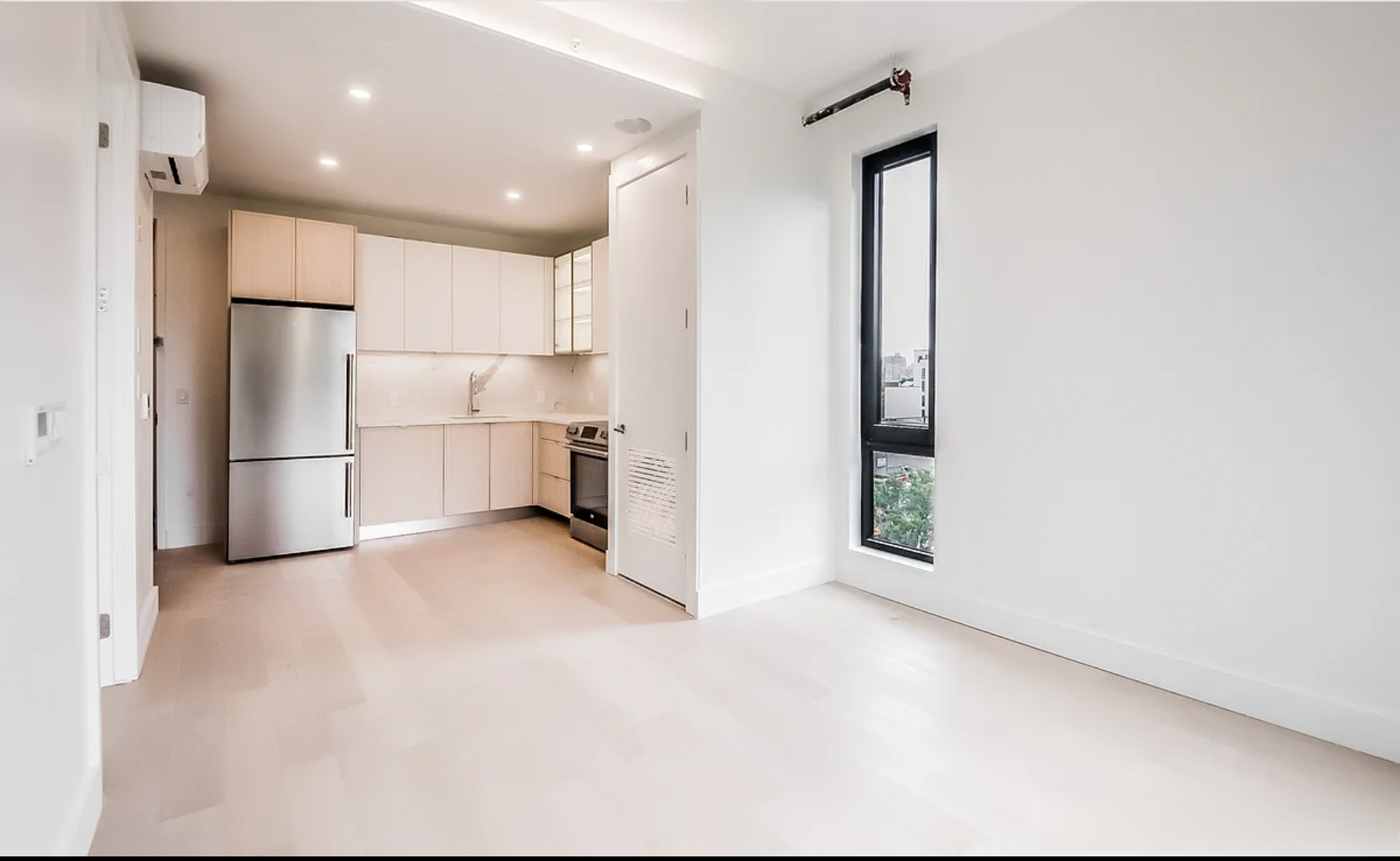 a view of a kitchen with a refrigerator and a refrigerator