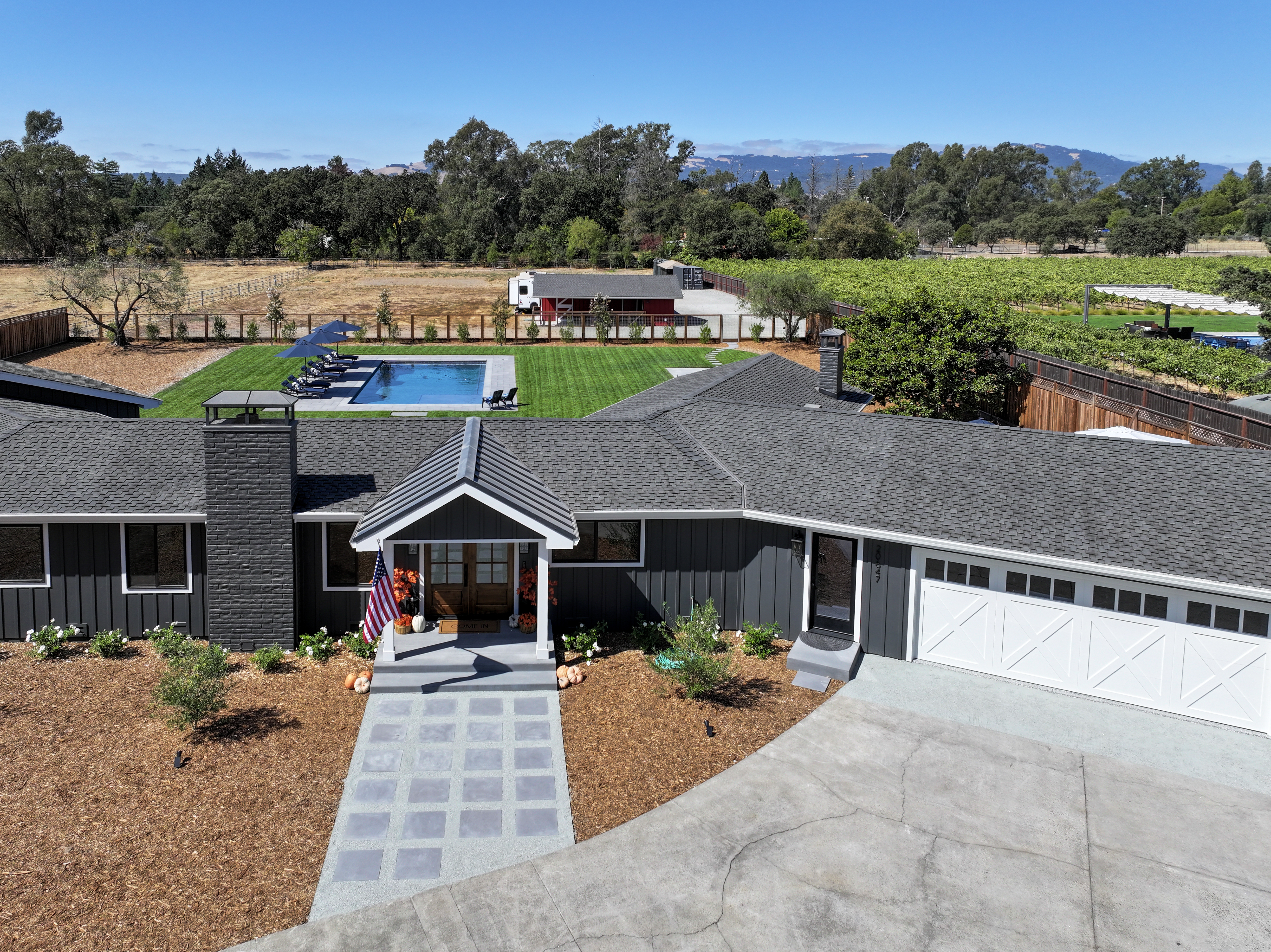 a view of house with outdoor space and swimming pool