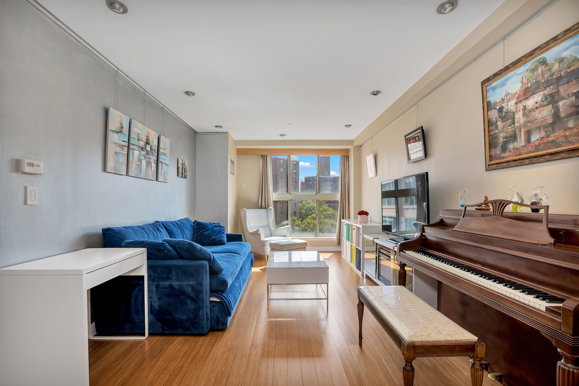 a living room with furniture and a piano