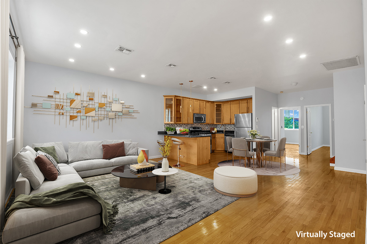 a living room with furniture and a view of kitchen