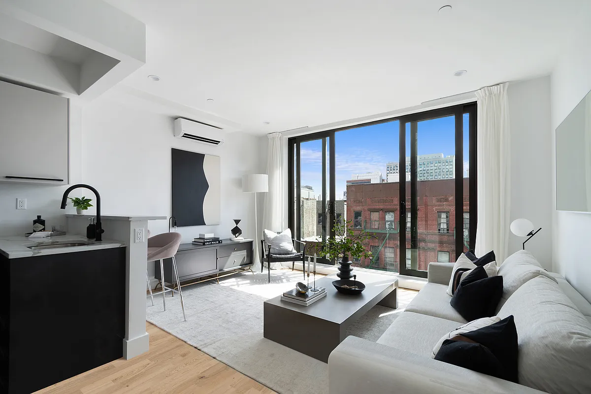 a living room with furniture and large windows