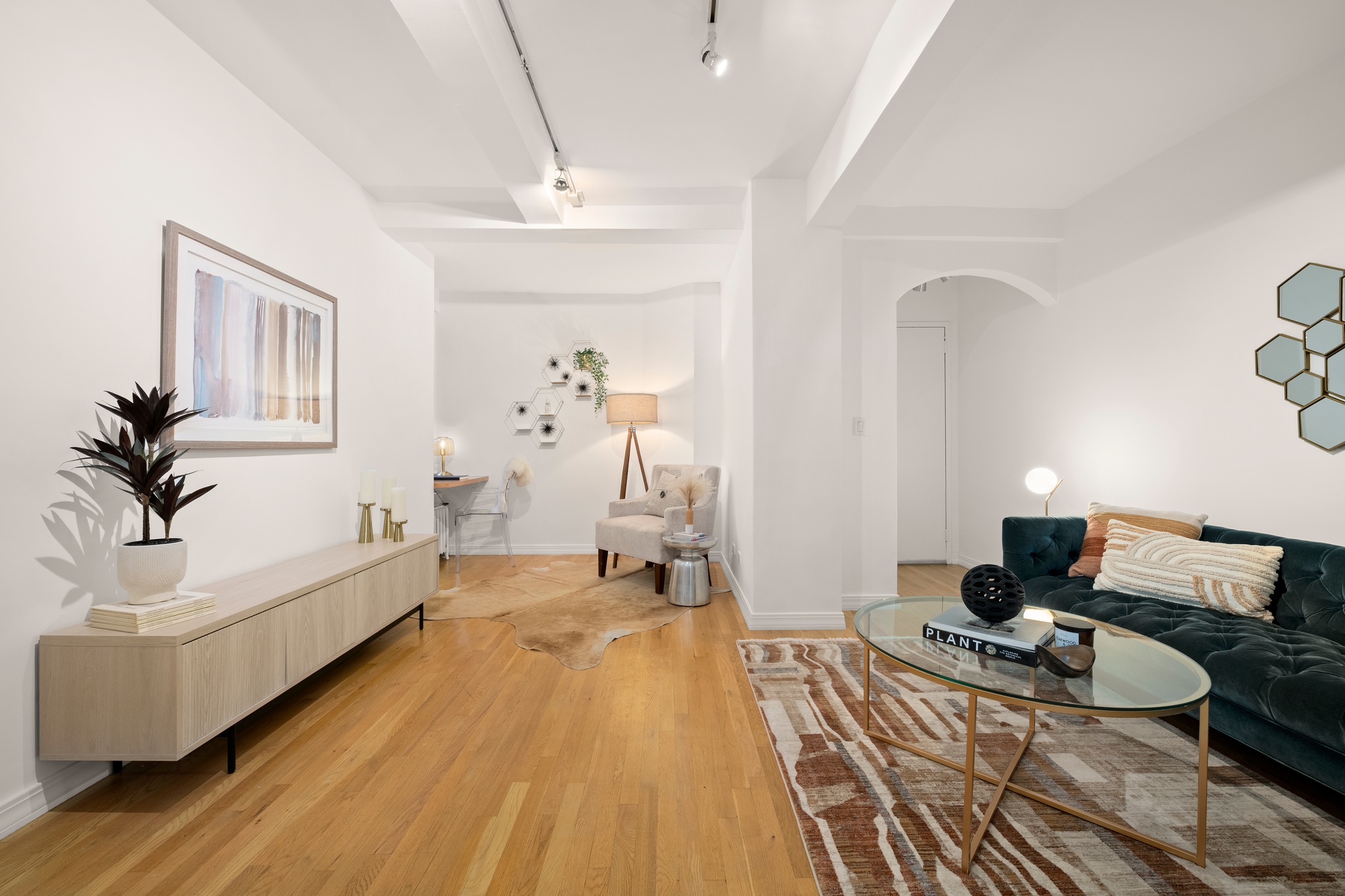 a living room with furniture and a wooden floor