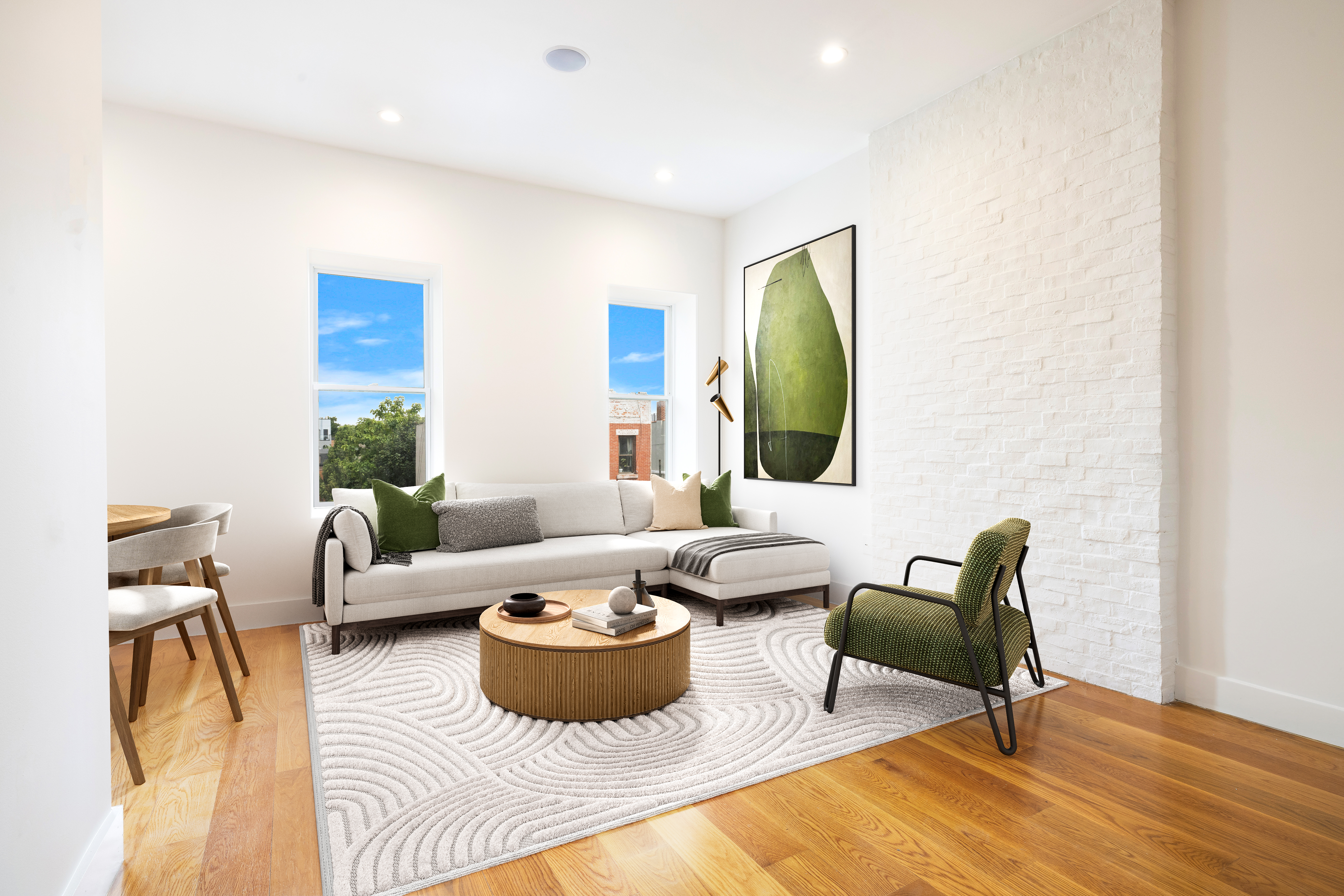 a living room with furniture and a potted plant